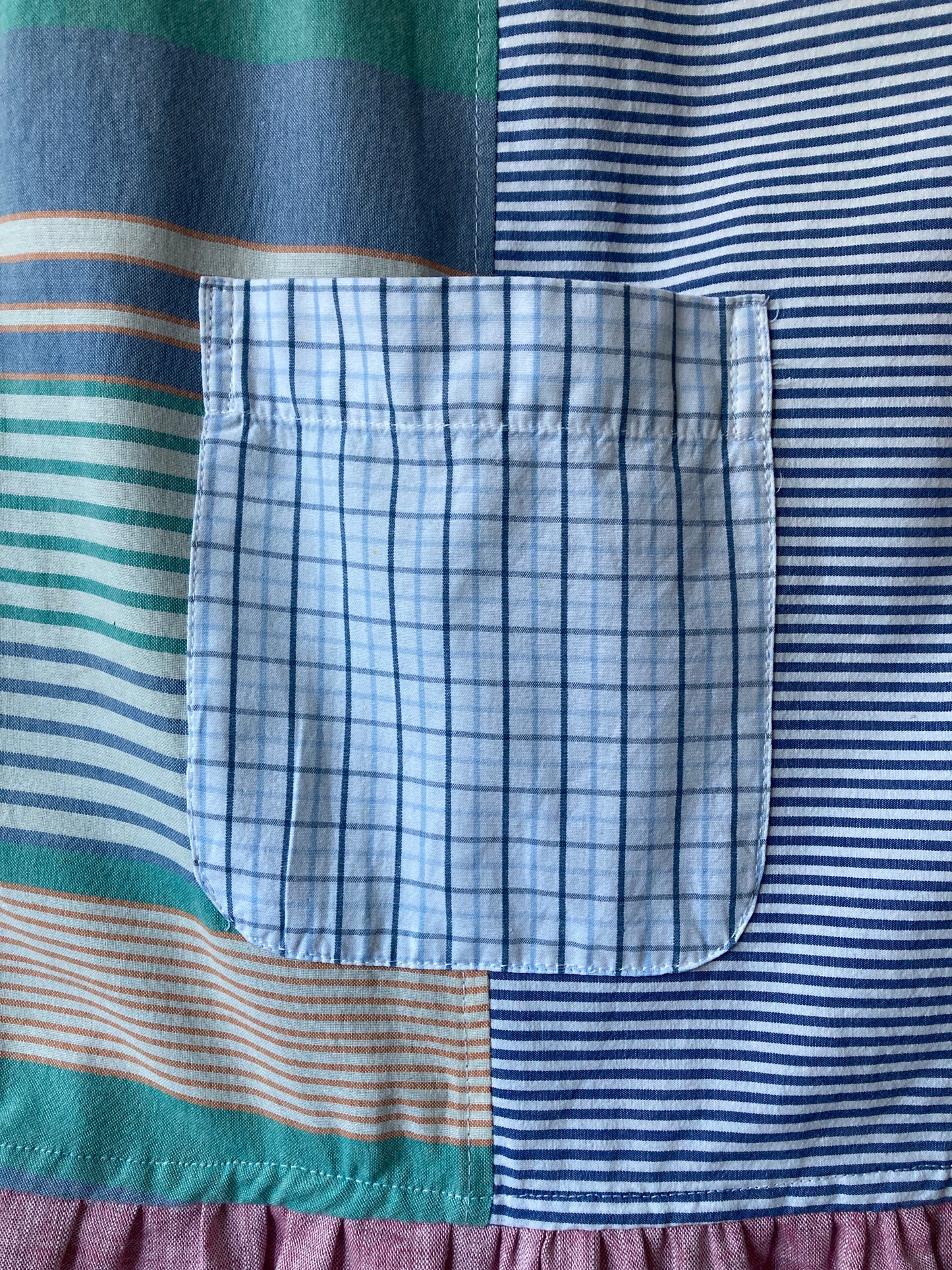 Handmade patchwork dress made from recycled cotton shirts using a vintage 1980s pattern. Boat neck. Pocket on bodice. Drop waist (close-up of pocket)