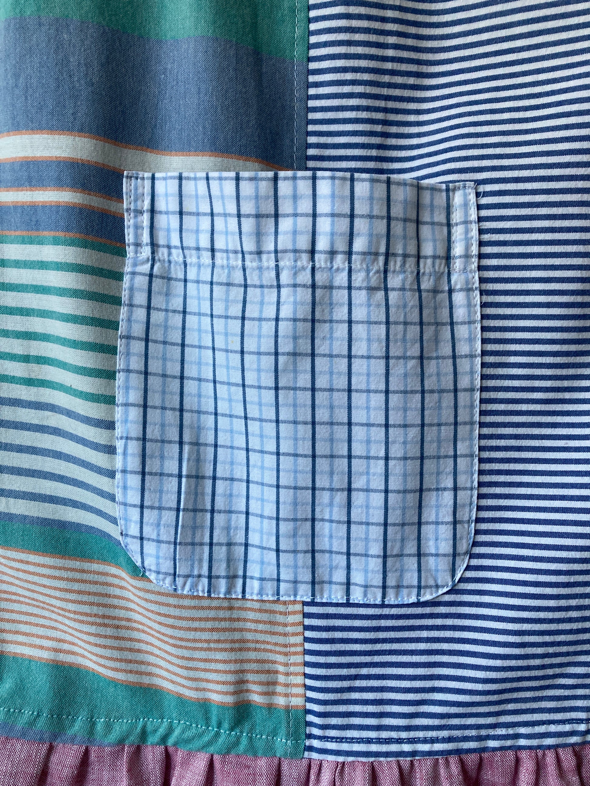 Handmade patchwork dress made from recycled cotton shirts using a vintage 1980s pattern. Boat neck. Pocket on bodice. Drop waist (close-up of pocket)