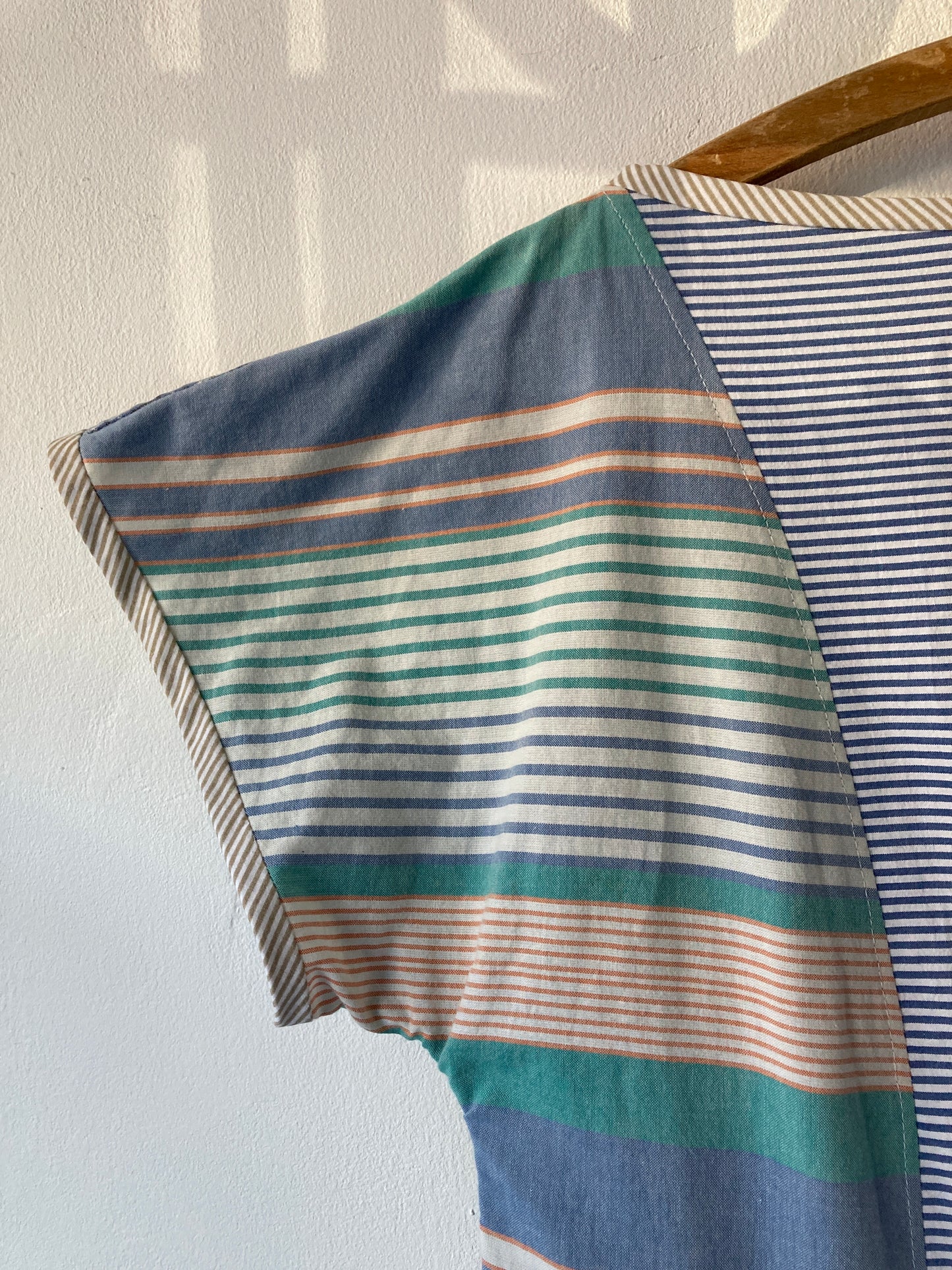 Handmade patchwork dress made from recycled cotton shirts using a vintage 1980s pattern. Boat neck. Pocket on bodice. Drop waist (close-up of sleeve)