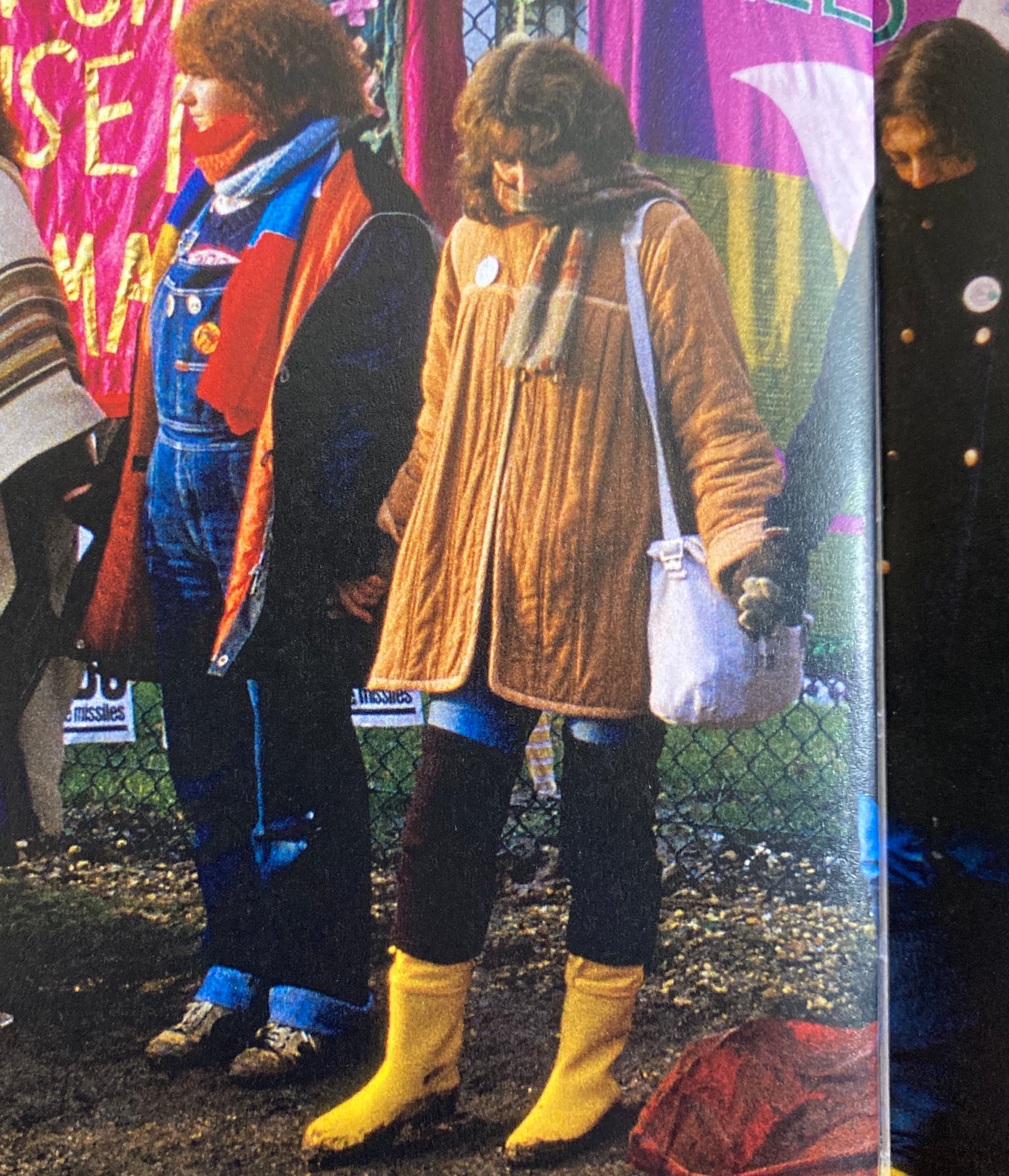A woman protesting at the Greenham Common airbase in the 80s wearing a brown quilted jacket