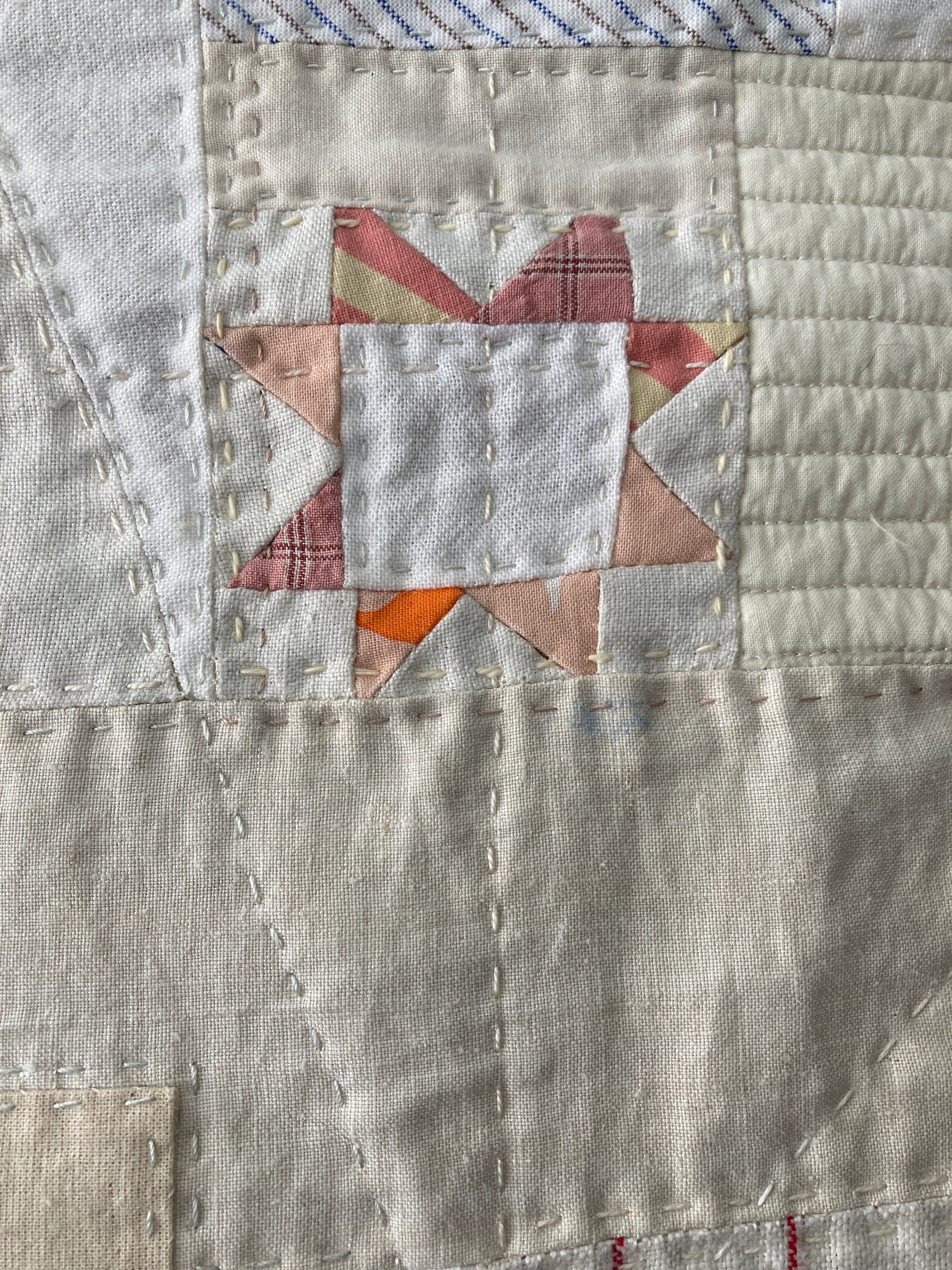 Wallhanging made from precious neutral and pastel-coloured scraps patchworked together and quilted in an improv fashion (detail)