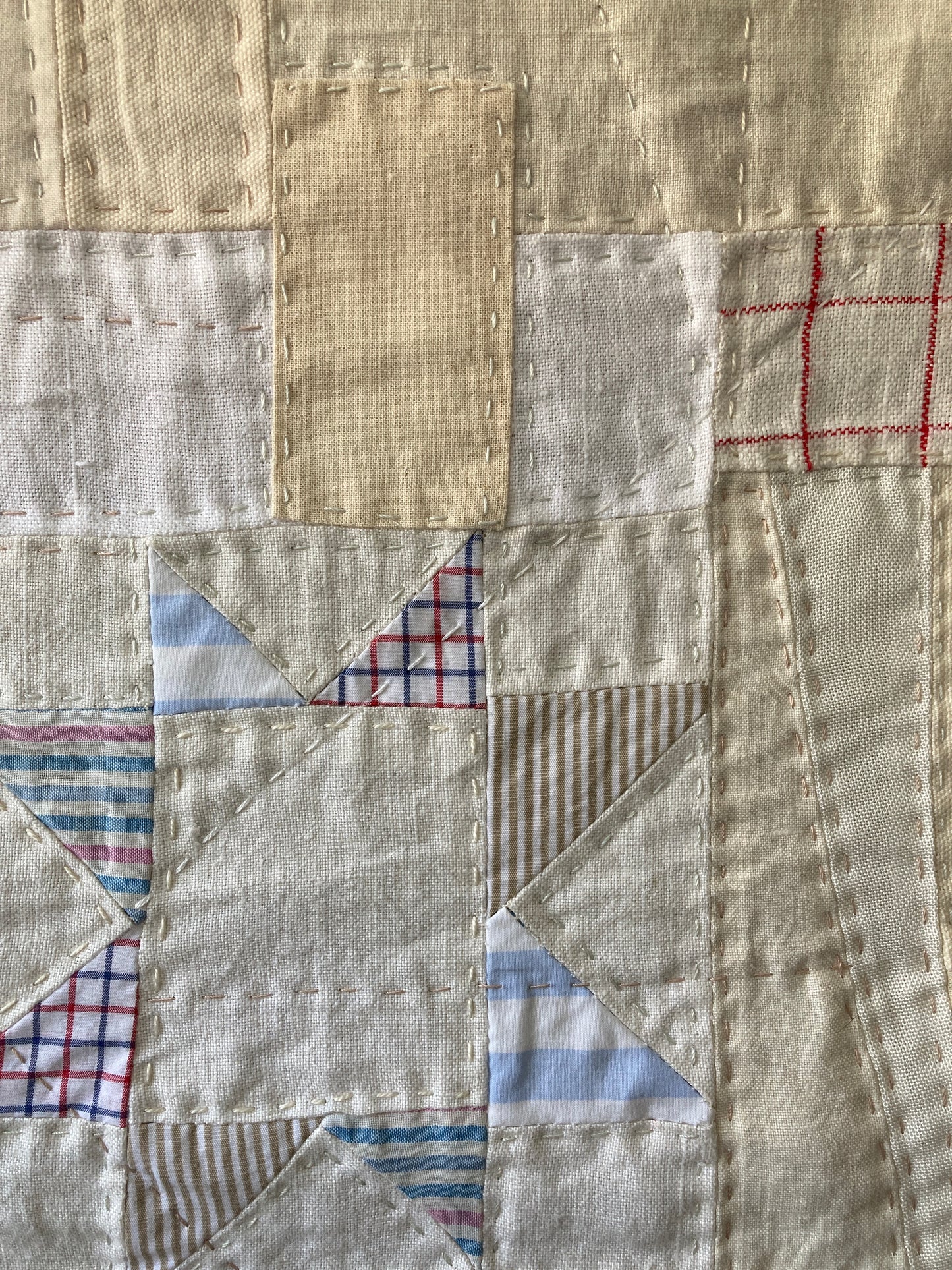 Wallhanging made from precious neutral and pastel-coloured scraps patchworked together and quilted in an improv fashion (detail)