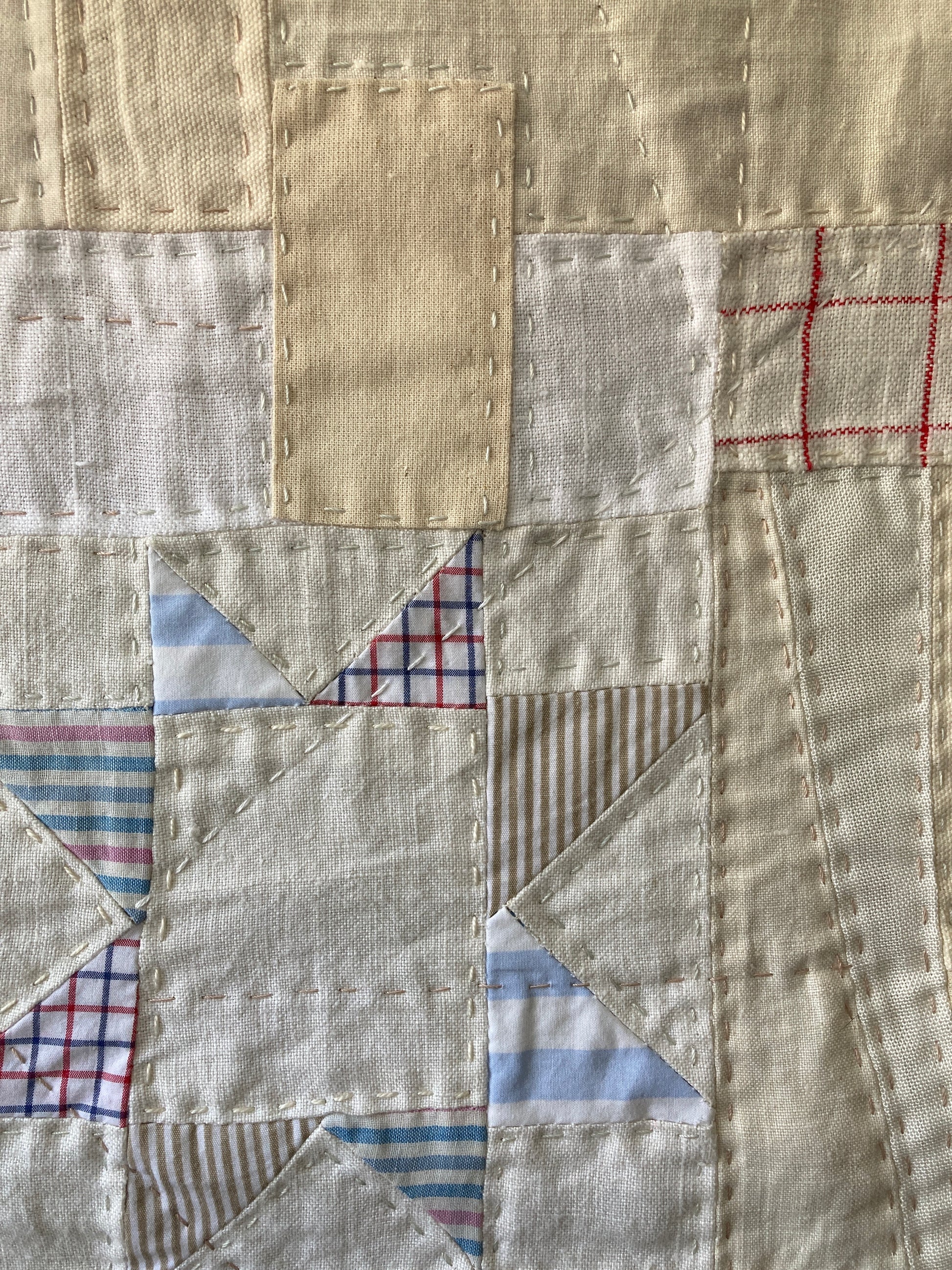 Wallhanging made from precious neutral and pastel-coloured scraps patchworked together and quilted in an improv fashion (detail)