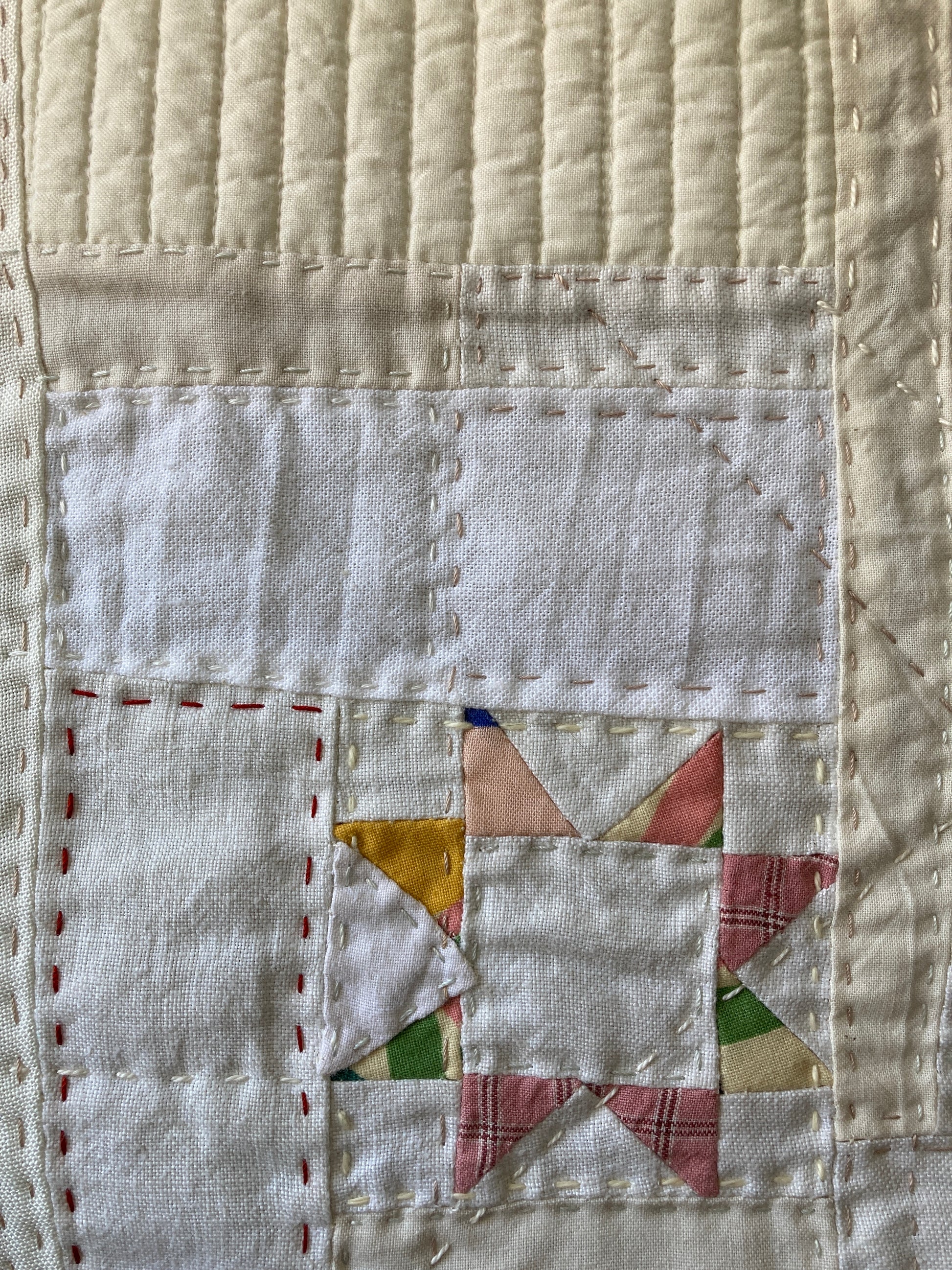 Wallhanging made from precious neutral and pastel-coloured scraps patchworked together and quilted in an improv fashion (detail)