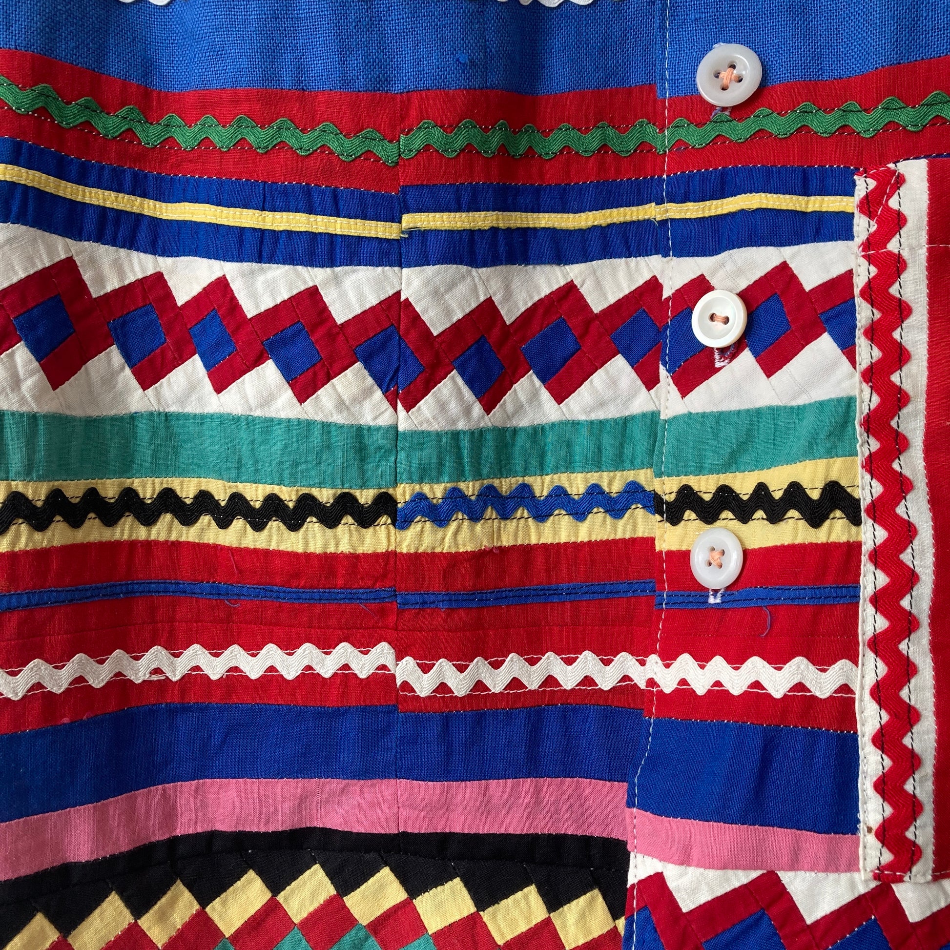 A short-sleeved shirt made from brightly coloured seminole patchwork (close-up)