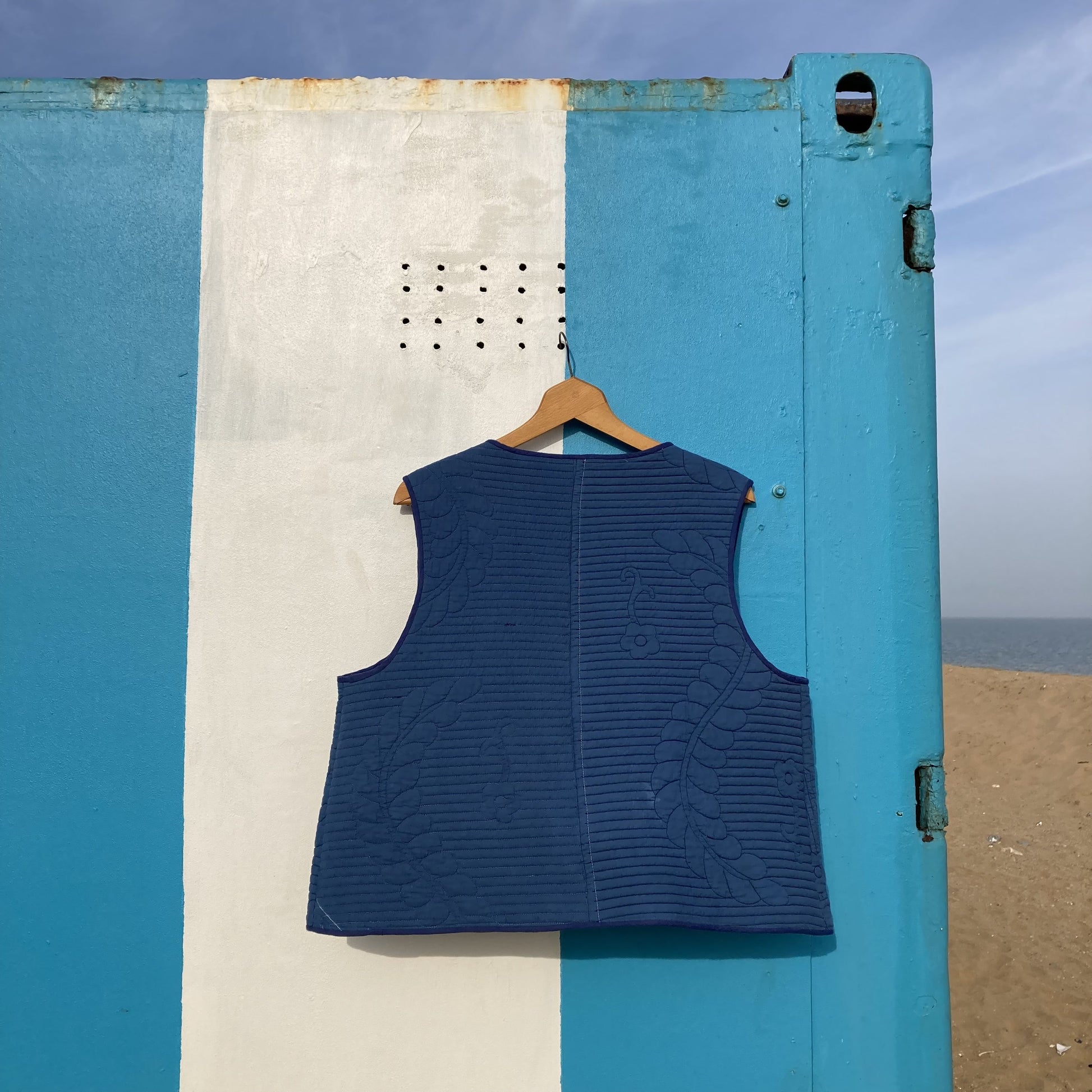 blue tie-front gilet/vest/bodywarmer/waistcoat made from a reclaimed quilt, image shows the back