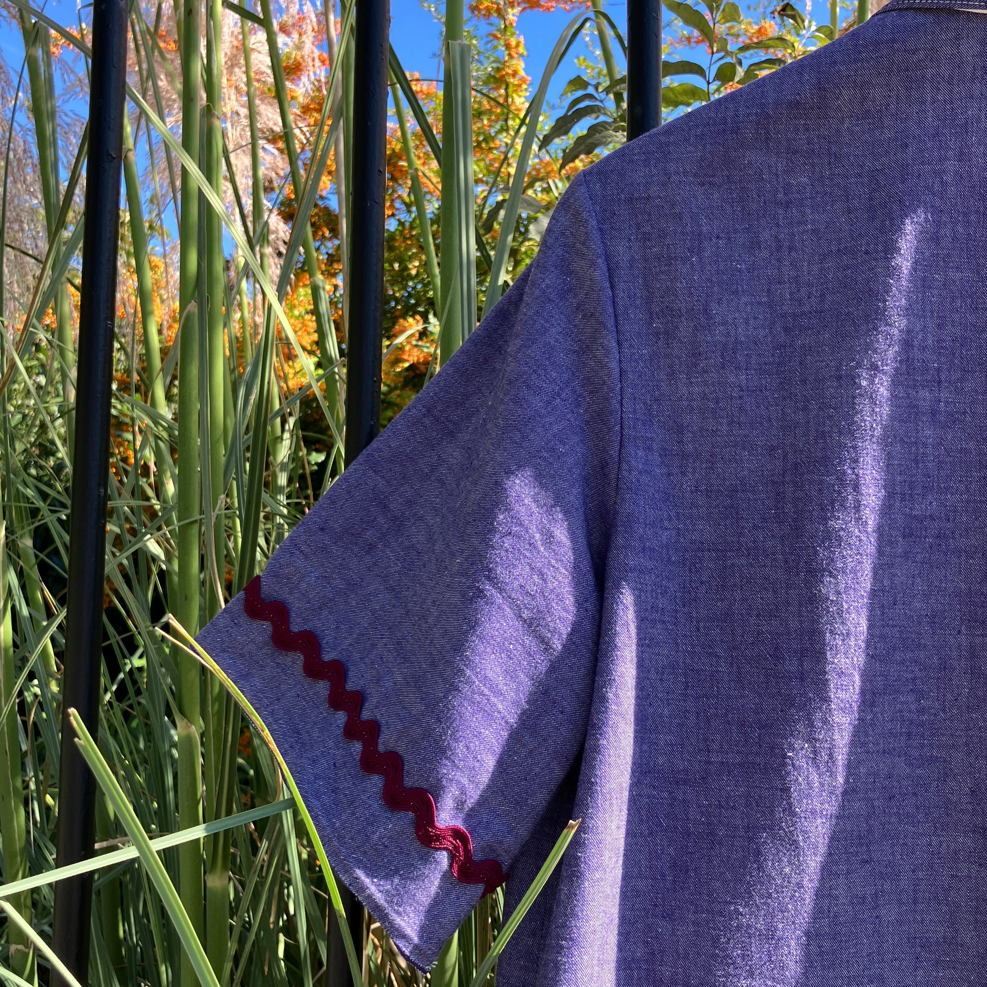 Reclaimed blue chambray shirt with star shaped buttons, birds on the pockets and rice-rac round the sleeves