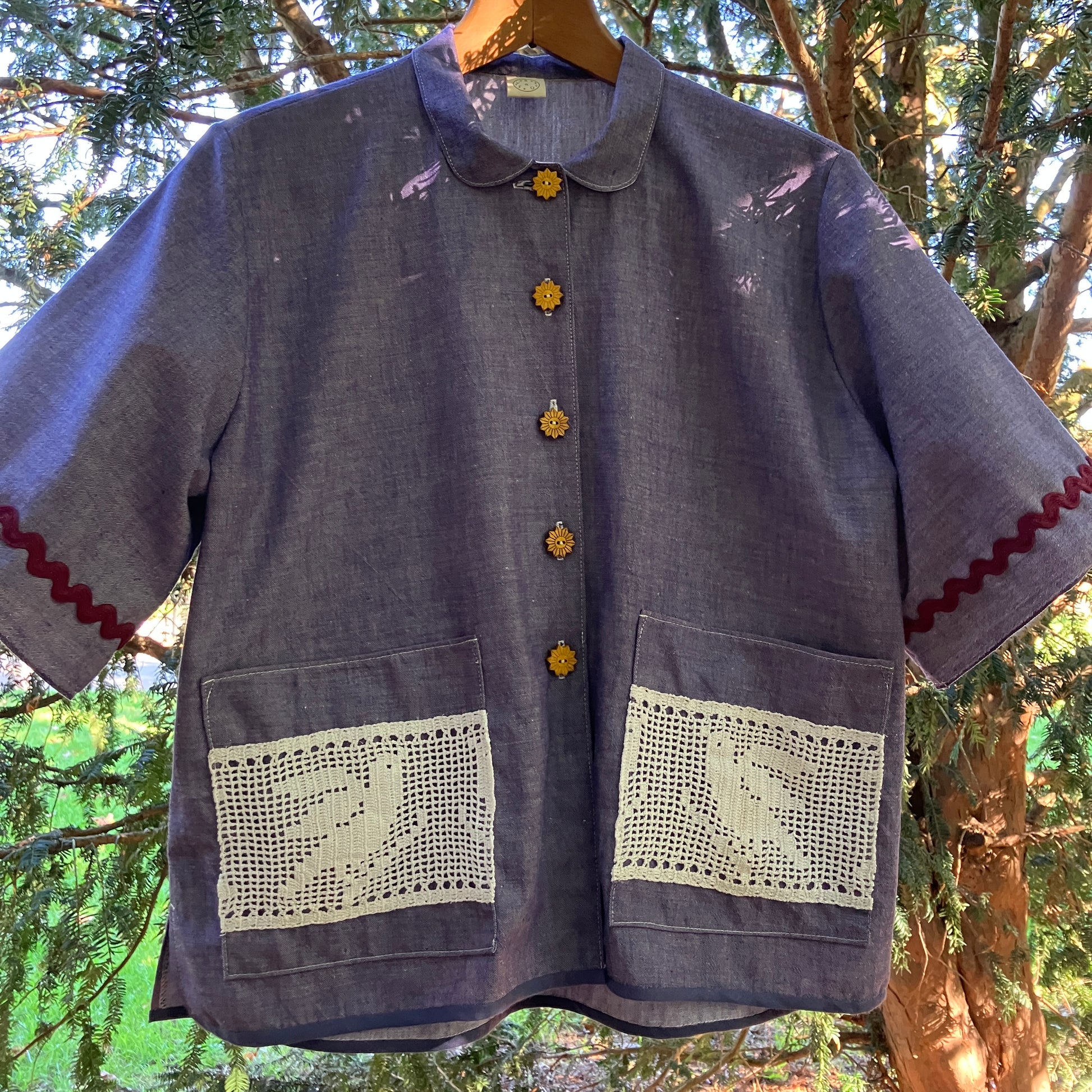 Reclaimed blue chambray shirt with star shaped buttons, birds on the pockets and rice-rac round the sleeves