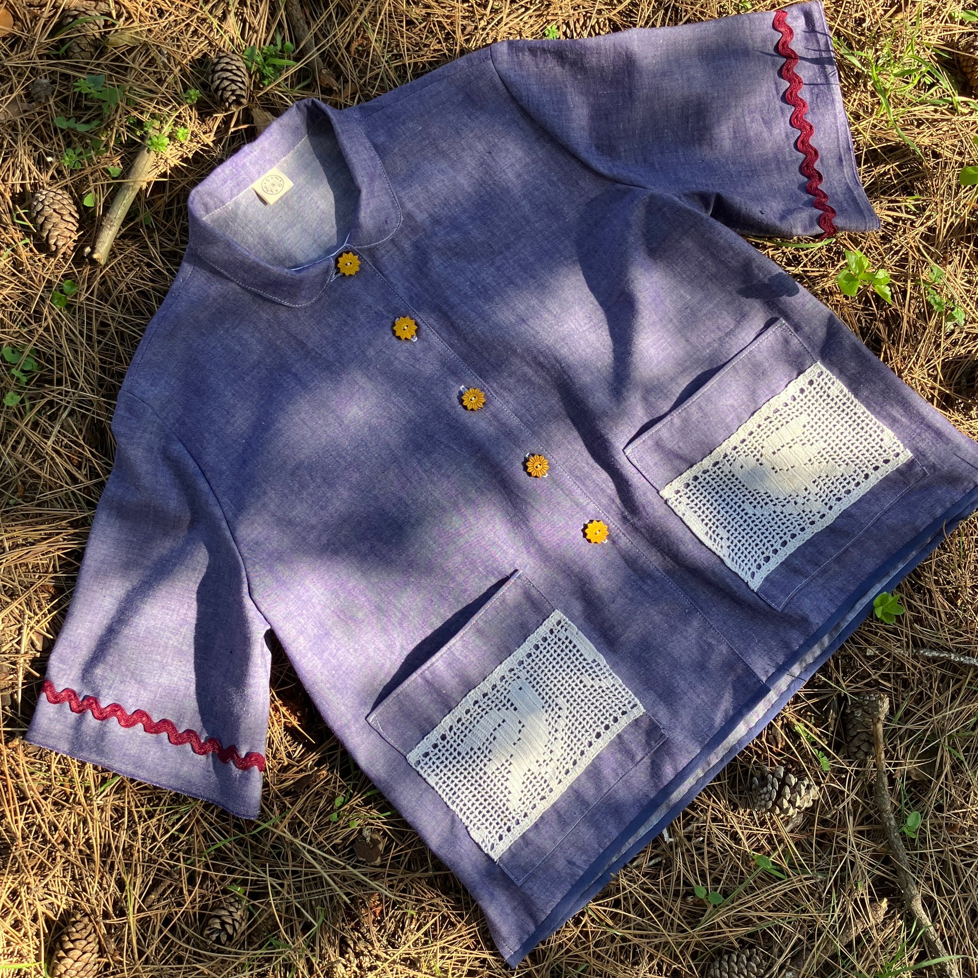 Reclaimed blue chambray shirt with star shaped buttons, birds on the pockets and rice-rac round the sleeves