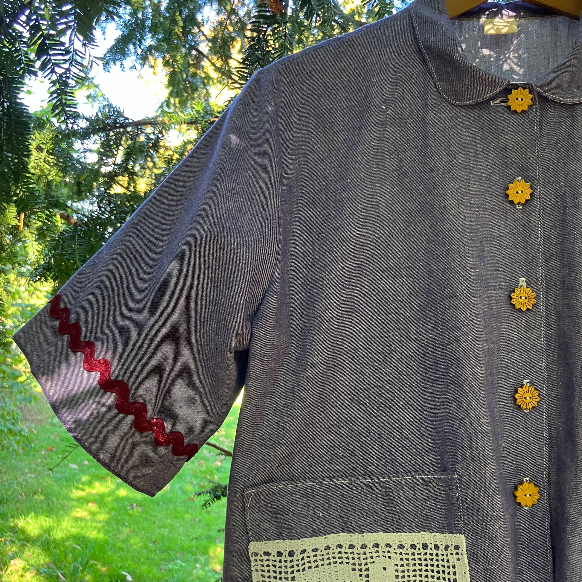 Reclaimed blue chambray shirt with star shaped buttons, birds on the pockets and rice-rac round the sleeves