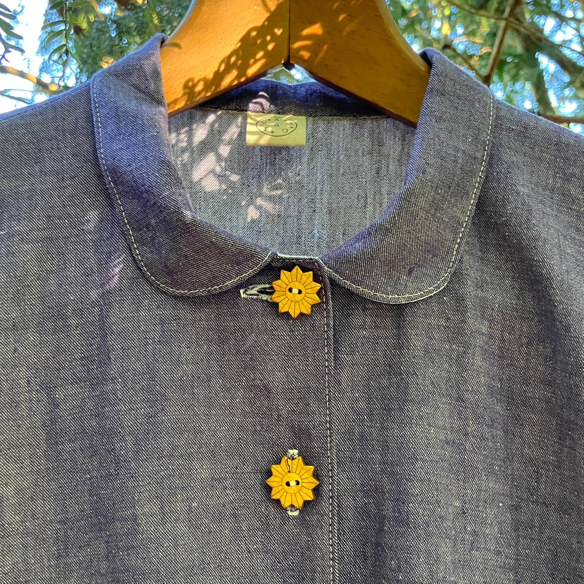 Reclaimed blue chambray shirt with star shaped buttons, birds on the pockets and rice-rac round the sleeves