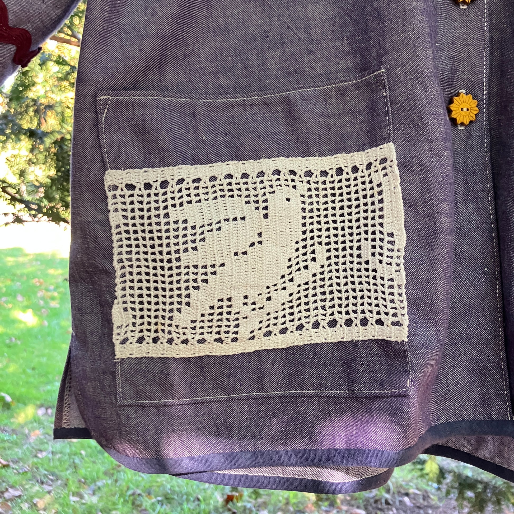 Reclaimed blue chambray shirt with star shaped buttons, birds on the pockets and rice-rac round the sleeves