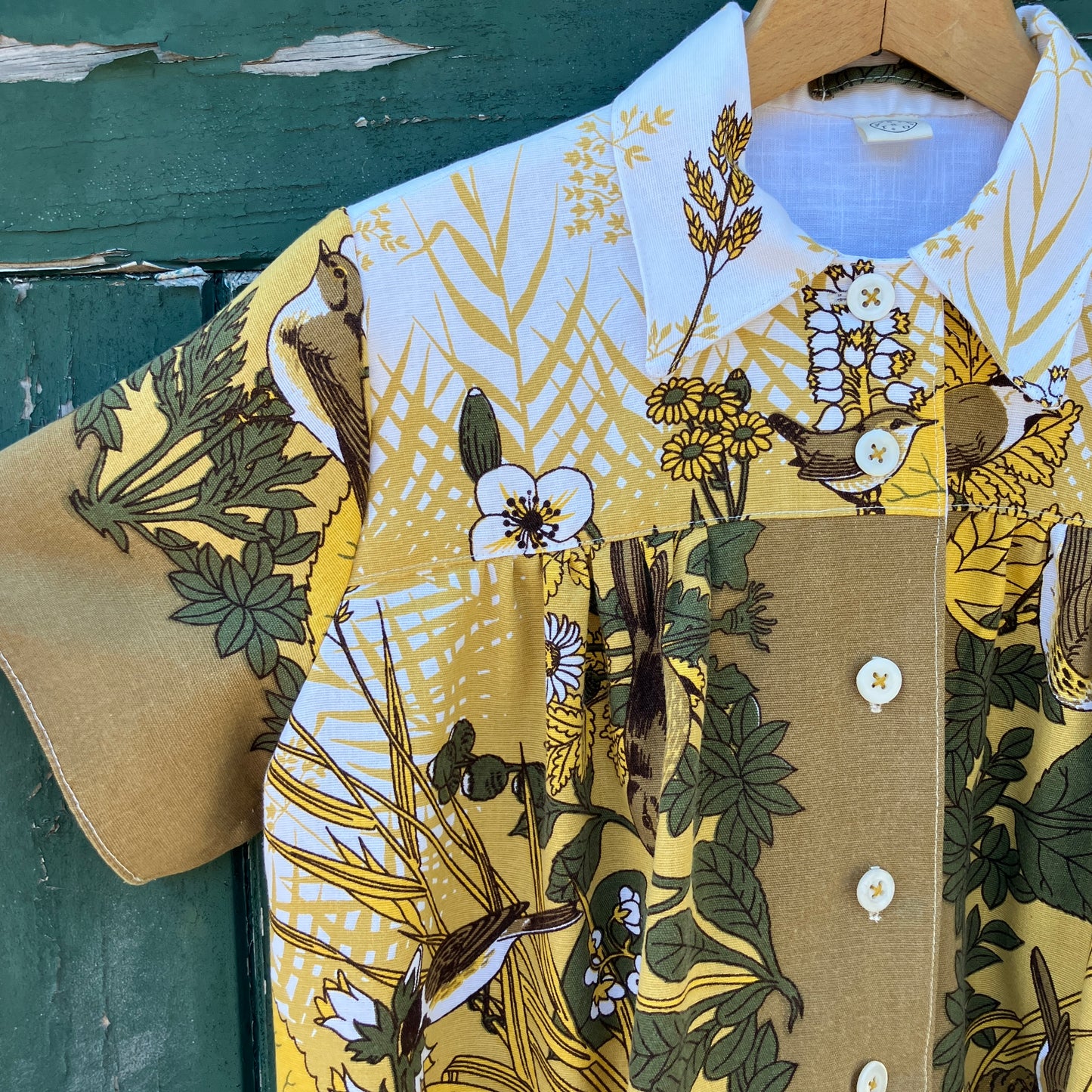 Shirt made from a recycled vintage 70s tablecloth featuring birds, birds nests, leaves, flowers and sheaves of wheat.