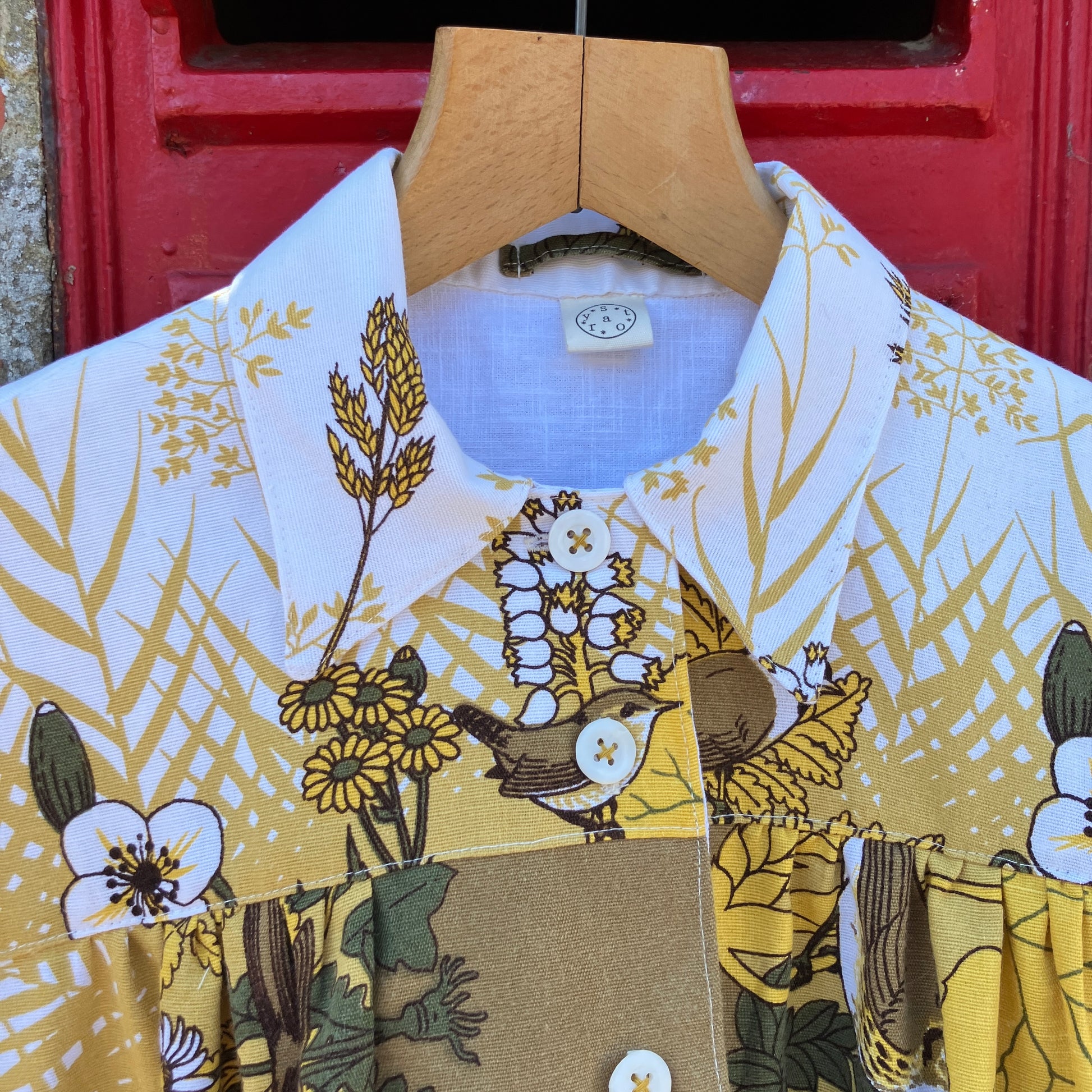 Shirt made from a recycled vintage 70s tablecloth featuring birds, birds nests, leaves, flowers and sheaves of wheat.