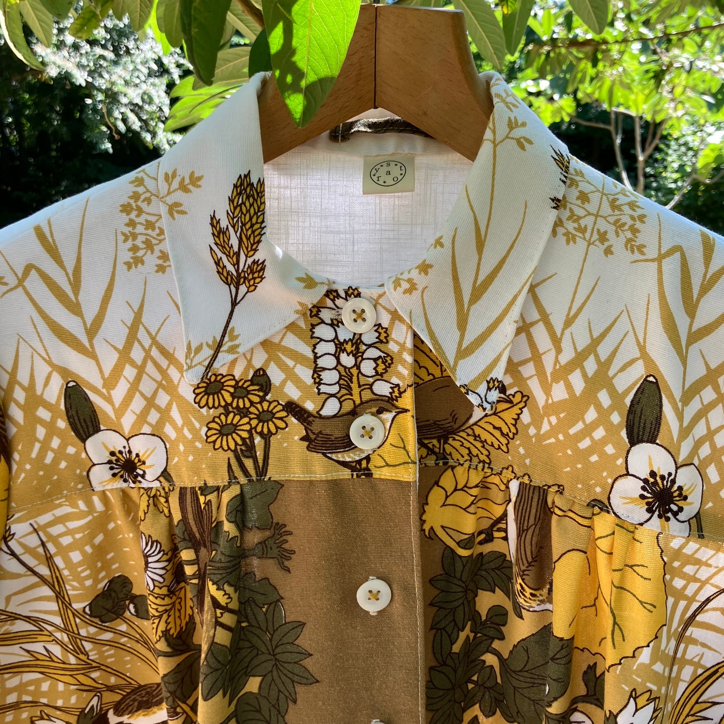 Shirt made from a recycled vintage 70s tablecloth featuring birds, birds nests, leaves, flowers and sheaves of wheat.