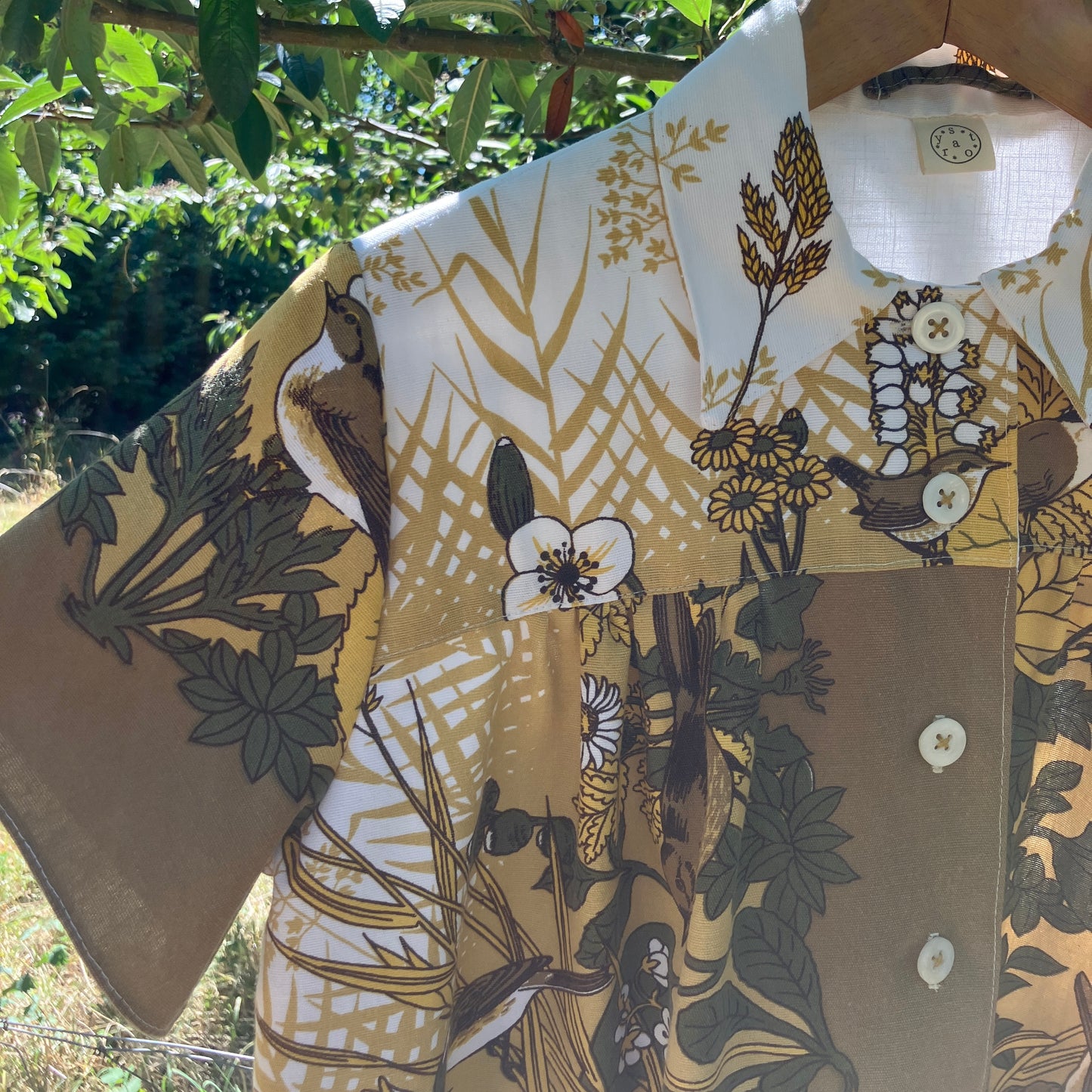 Shirt made from a recycled vintage 70s tablecloth featuring birds, birds nests, leaves, flowers and sheaves of wheat.