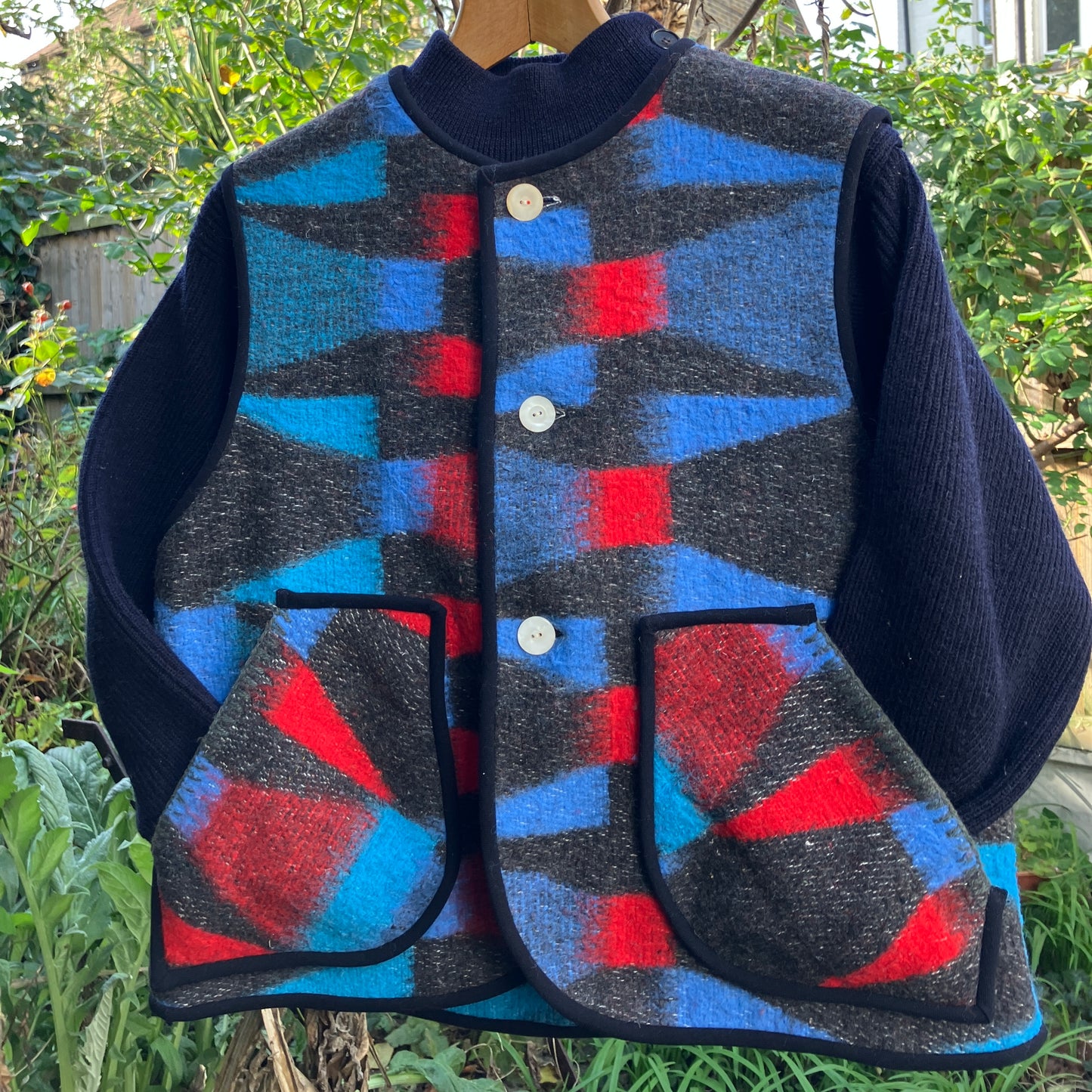 Cosy vest made from a striking geometric vintage blanket in shades of blue and red.