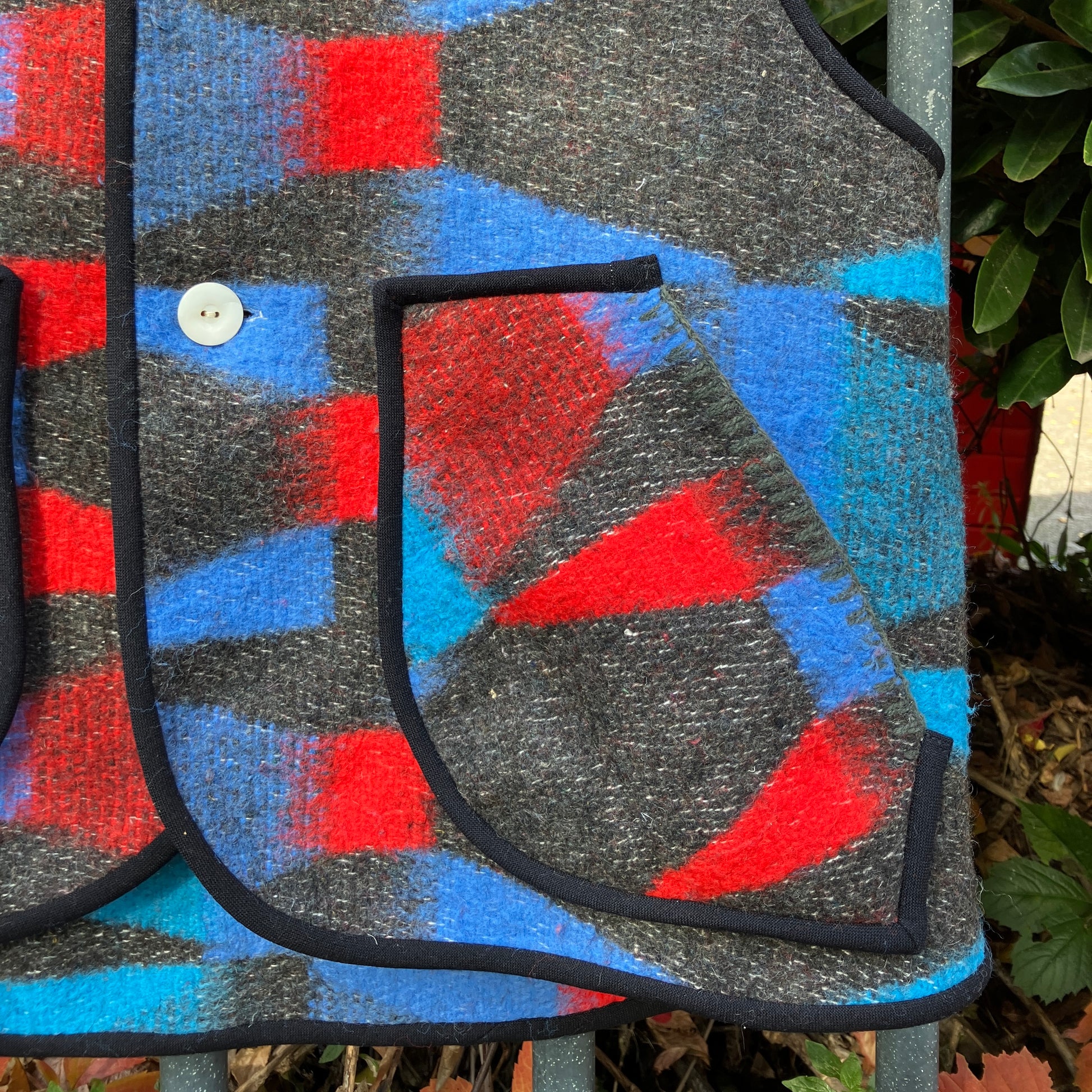 Cosy vest made from a striking geometric vintage blanket in shades of blue and red.