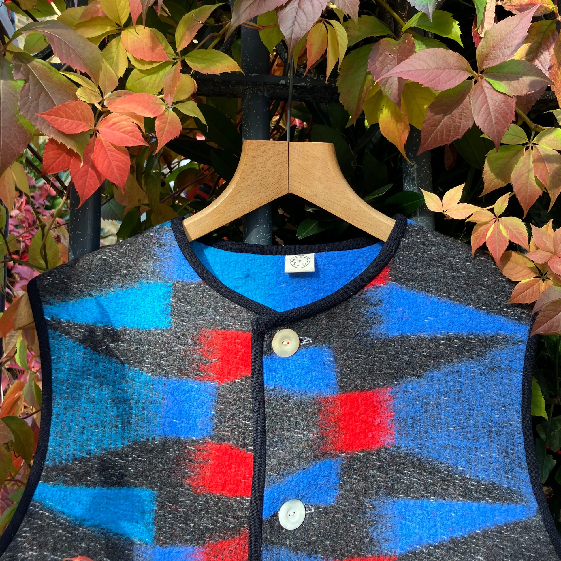 Cosy vest made from a striking geometric vintage blanket in shades of blue and red.