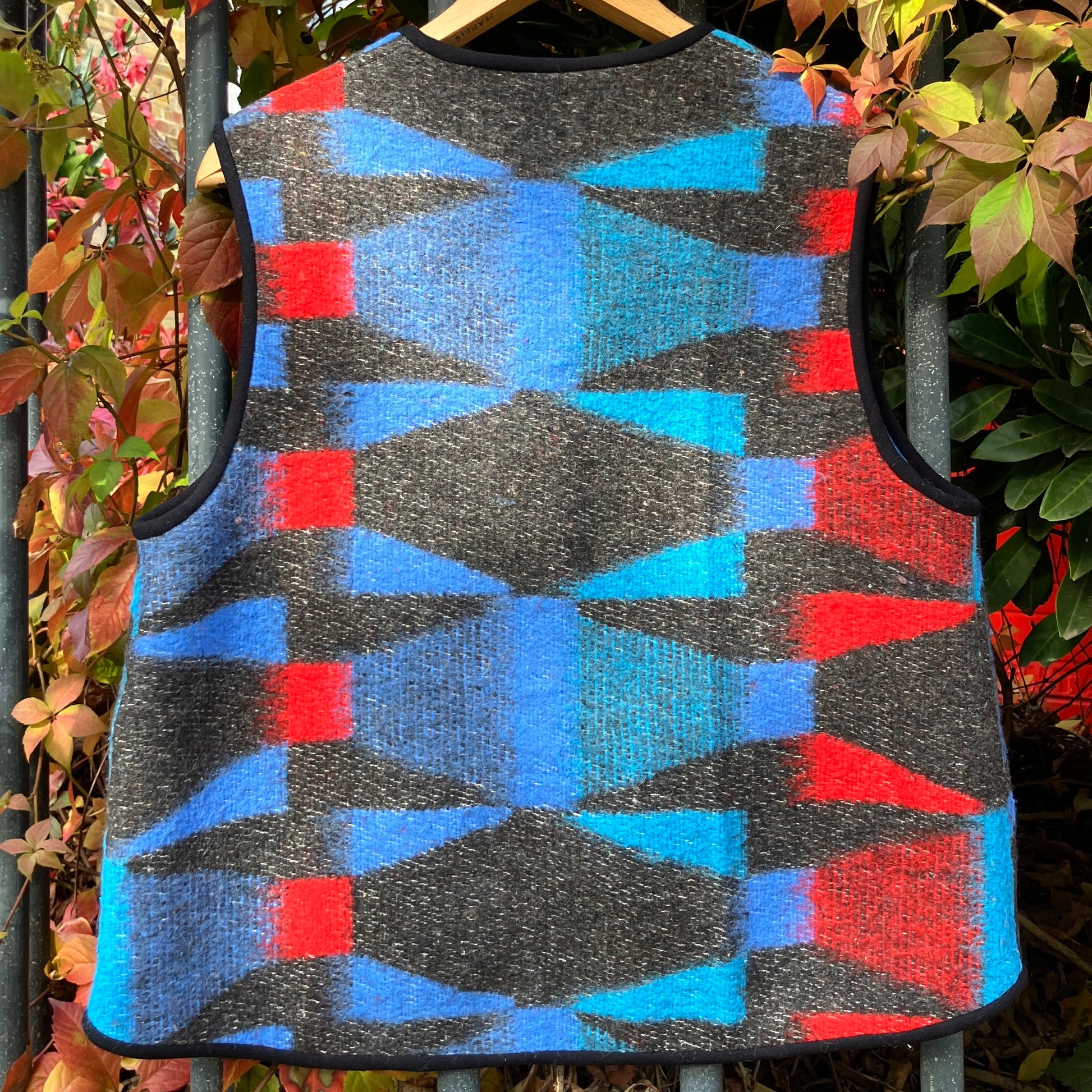Cosy vest made from a striking geometric vintage blanket in shades of blue and red.