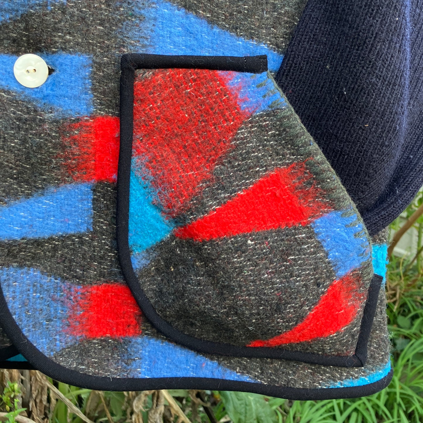 Cosy vest made from a striking geometric vintage blanket in shades of blue and red.
