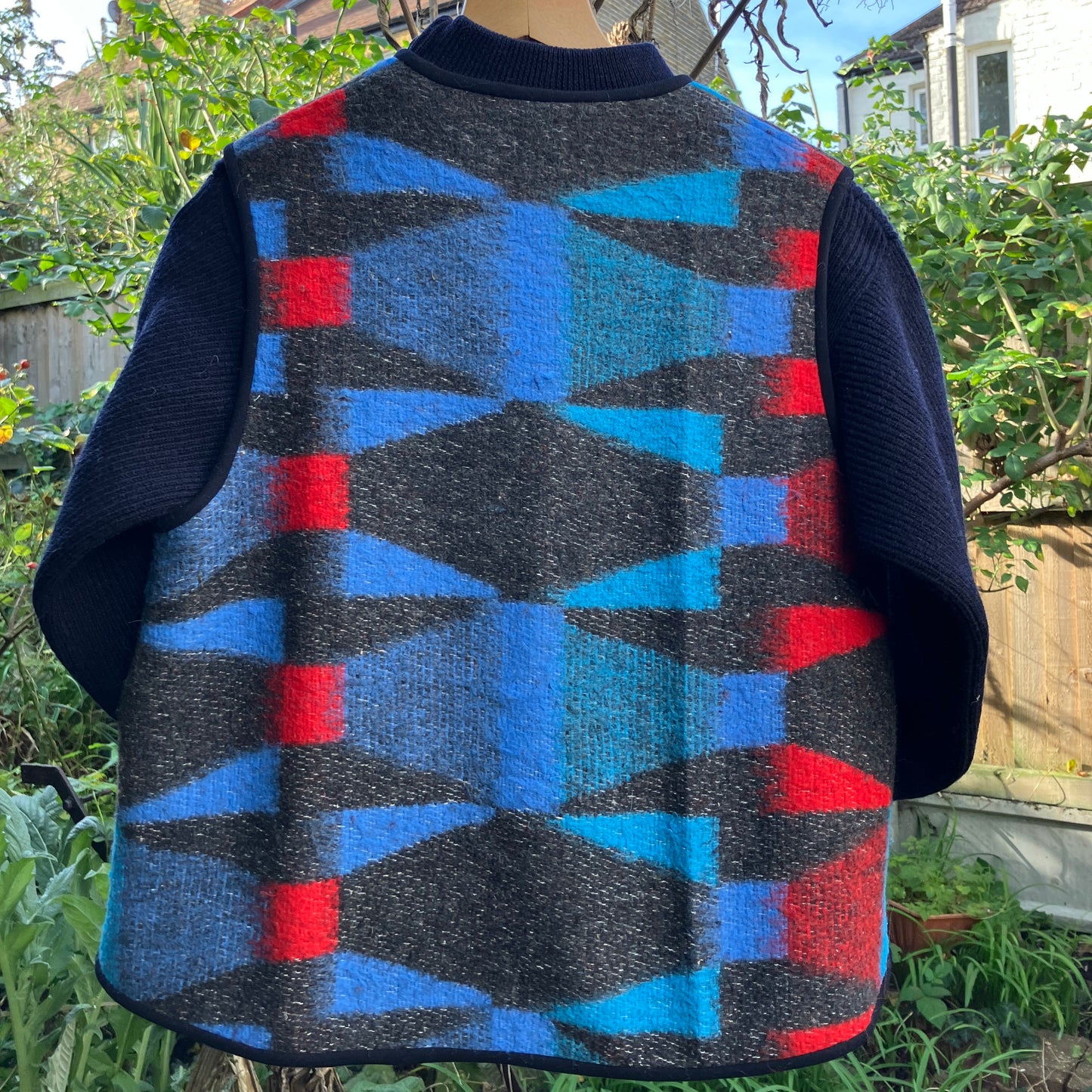 Cosy vest made from a striking geometric vintage blanket in shades of blue and red.
