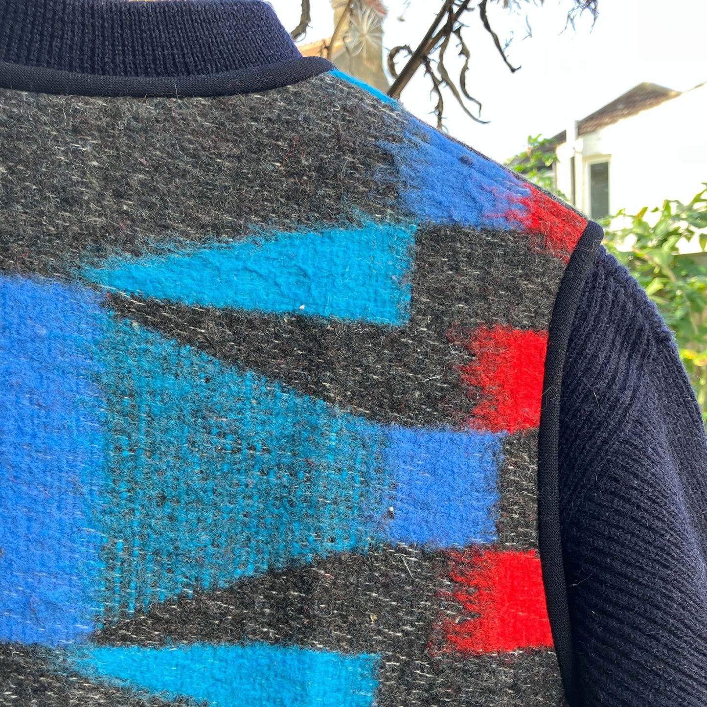 Cosy vest made from a striking geometric vintage blanket in shades of blue and red.