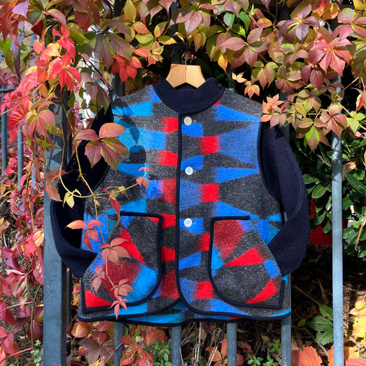 Cosy vest made from a striking geometric vintage blanket in shades of blue and red.
