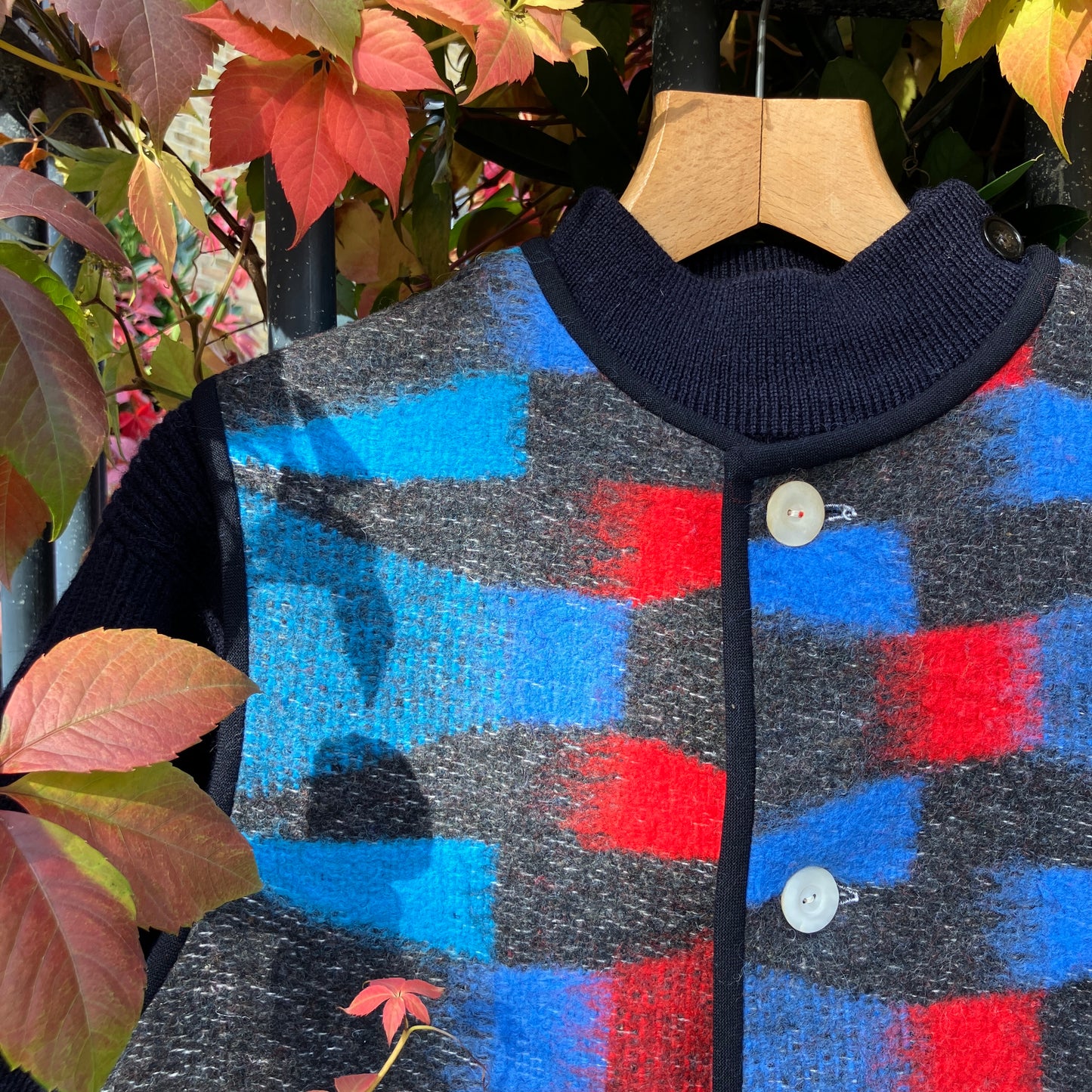 Cosy vest made from a striking geometric vintage blanket in shades of blue and red.