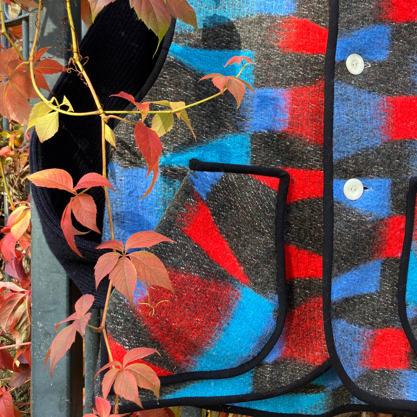 Cosy vest made from a striking geometric vintage blanket in shades of blue and red.