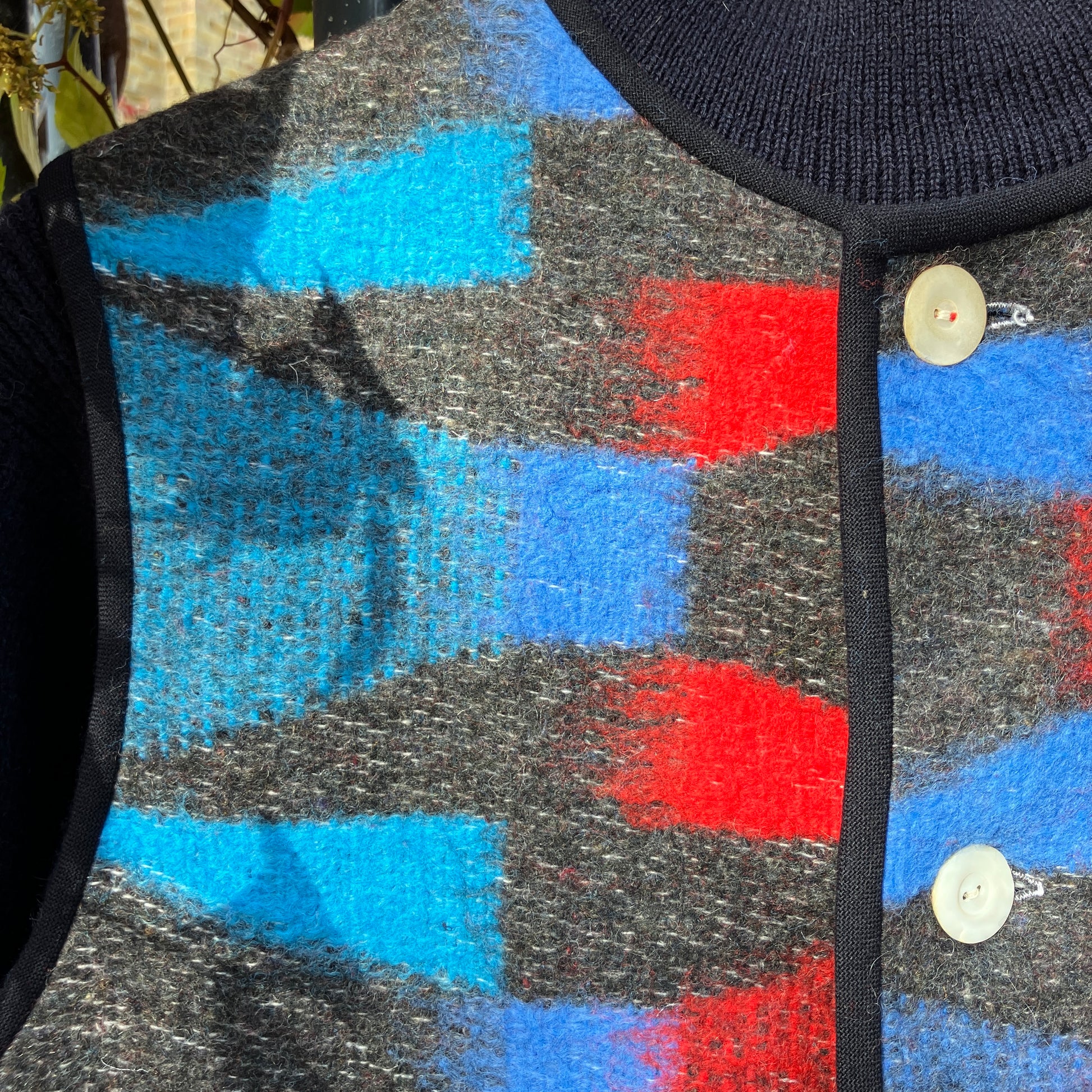 Cosy vest made from a striking geometric vintage blanket in shades of blue and red.
