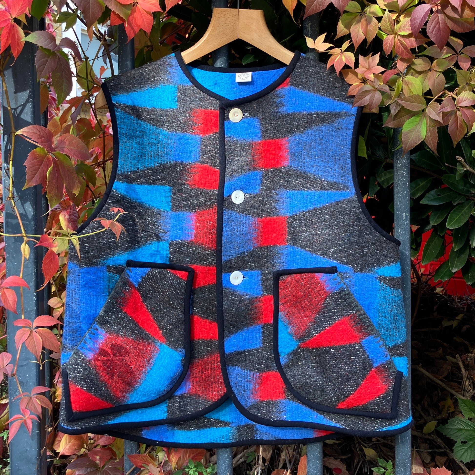 Cosy vest made from a striking geometric vintage blanket in shades of blue and red.