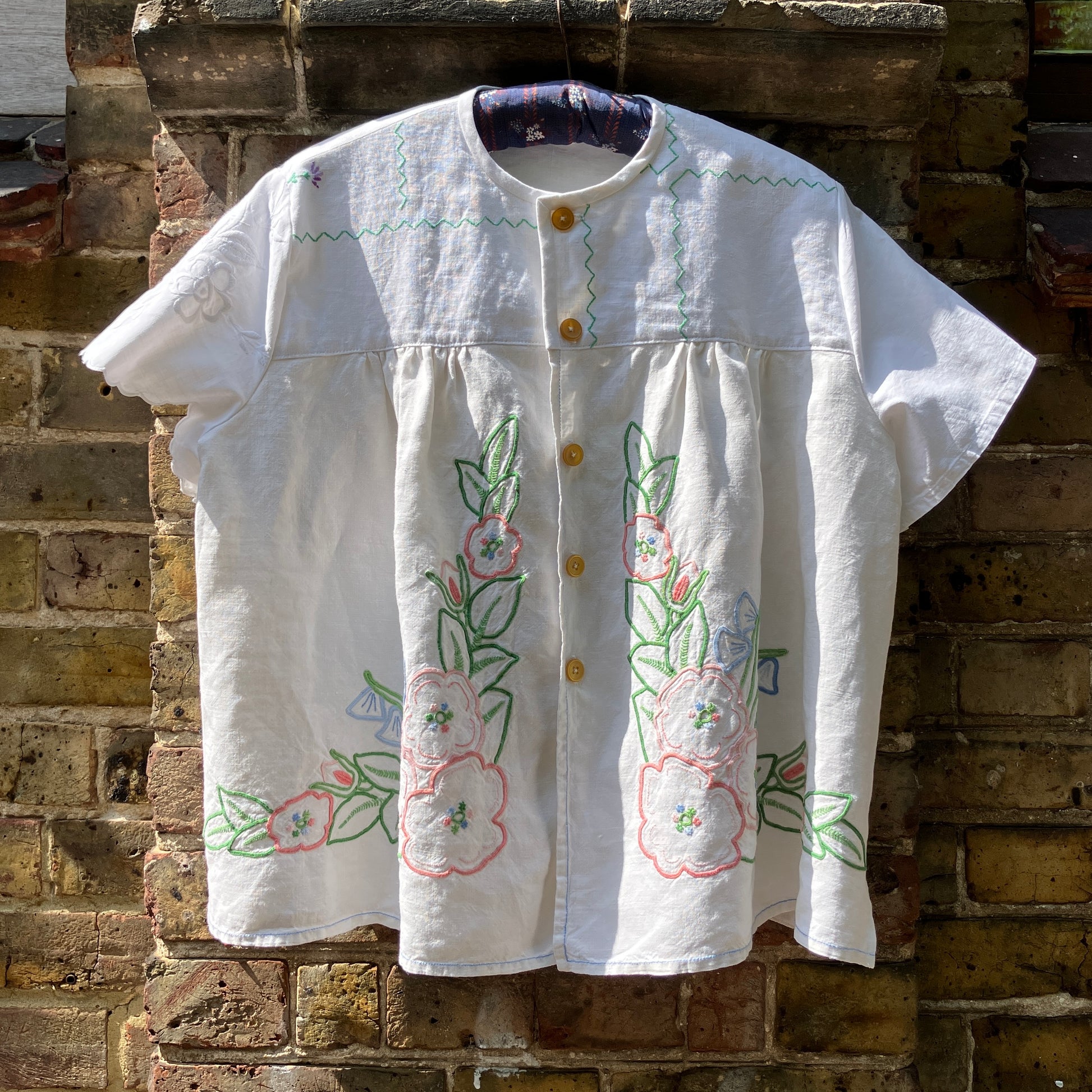 Swingy top made from found repurposed vintage tablecloths with embroidery and cutwork motifs.
