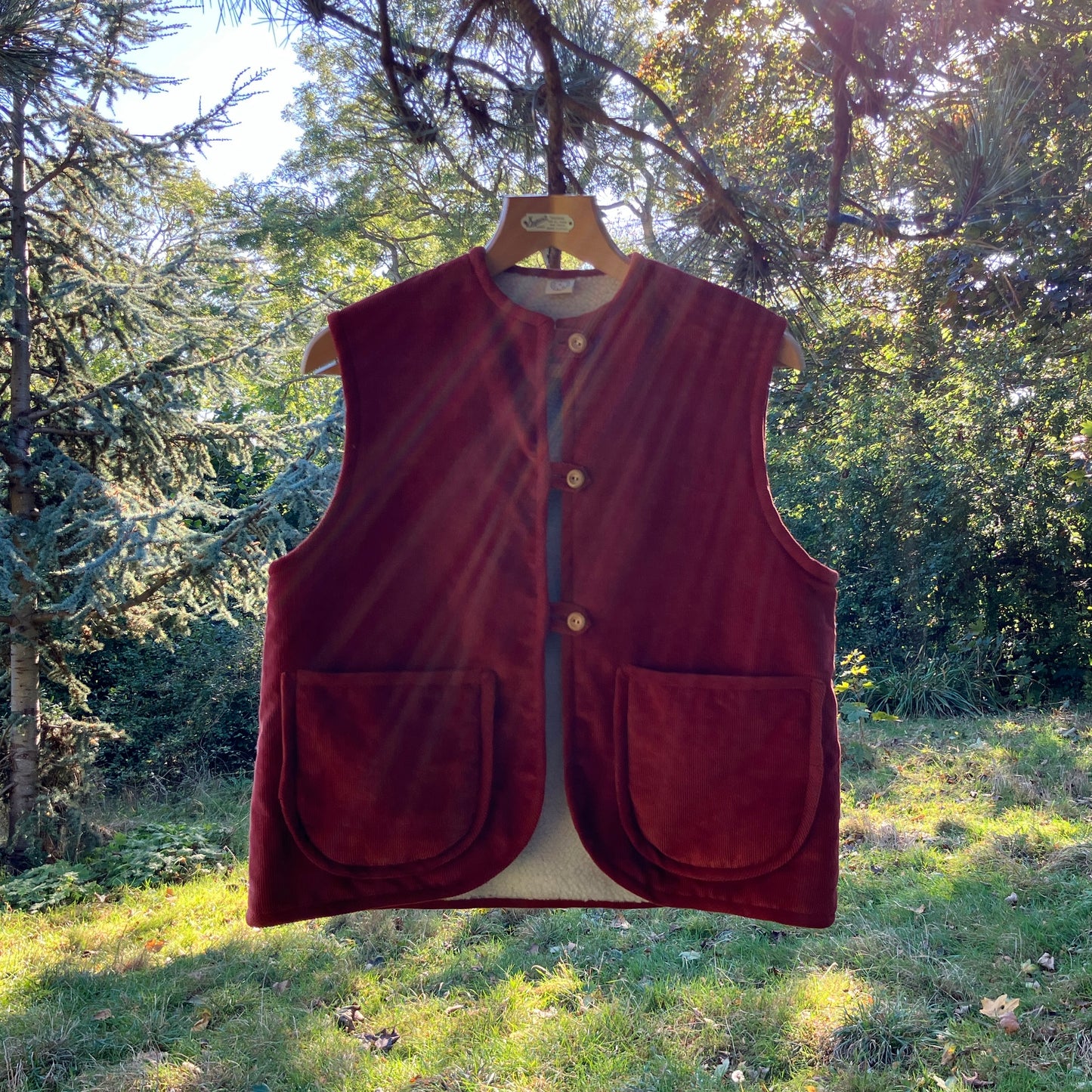 Cosy vest/waistcoat made from a secondhand remnant of rust-coloured corduroy, lined with found faux sheepskin fleece