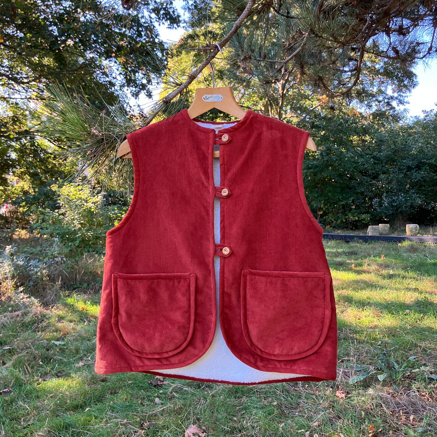 Cosy vest/waistcoat made from a secondhand remnant of rust-coloured corduroy, lined with found faux sheepskin fleece