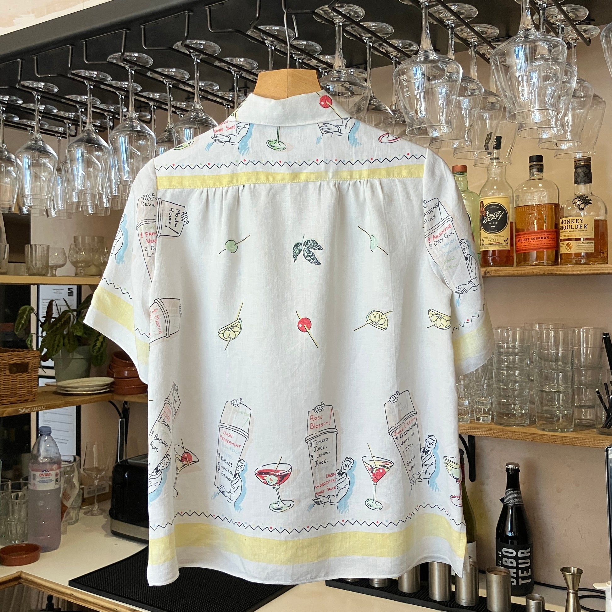 White shirt with cocktail-themed embroidery in a bar setting