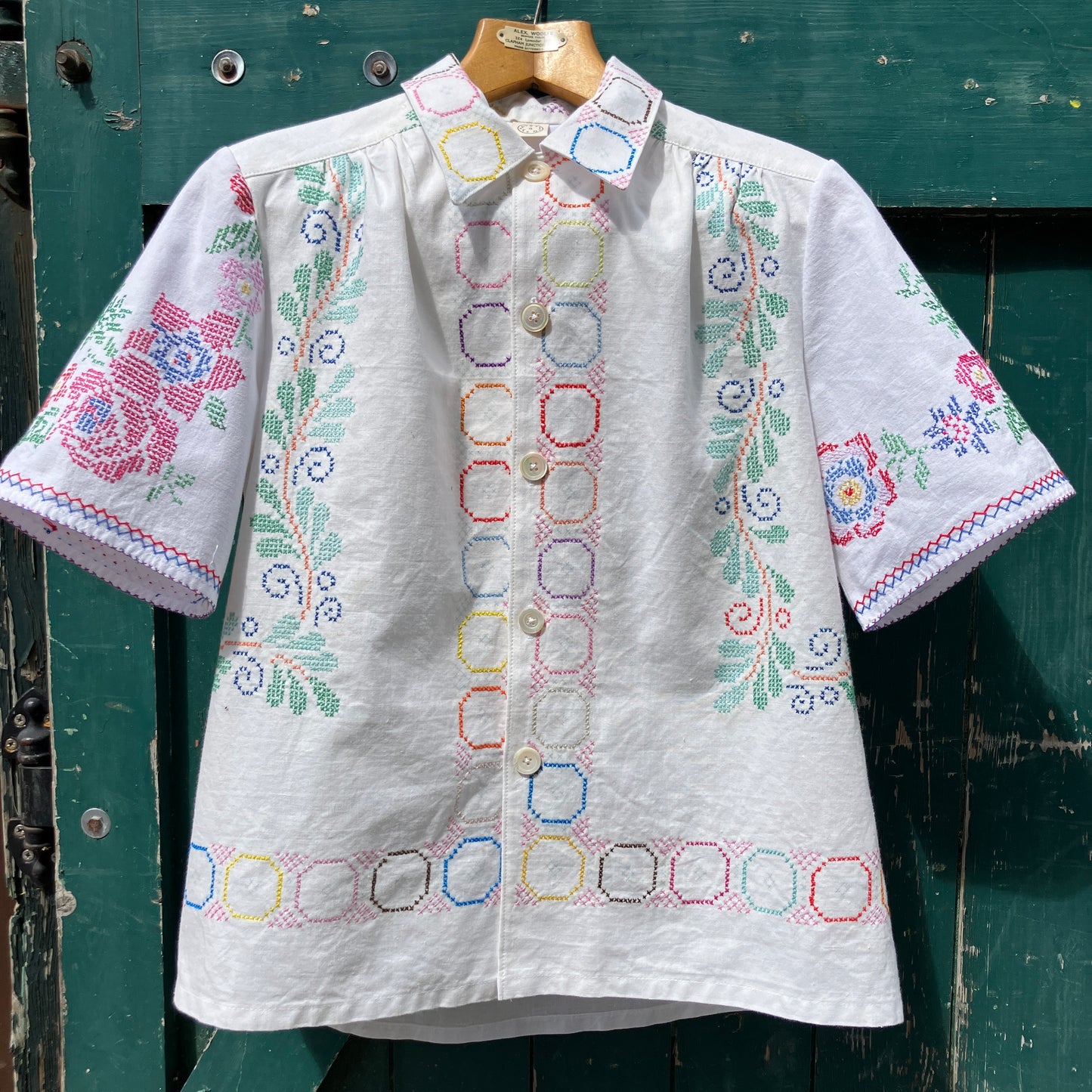 Shirt made from a selection of vintage cotton tablecloths with floral and geometric cross stitch patterns