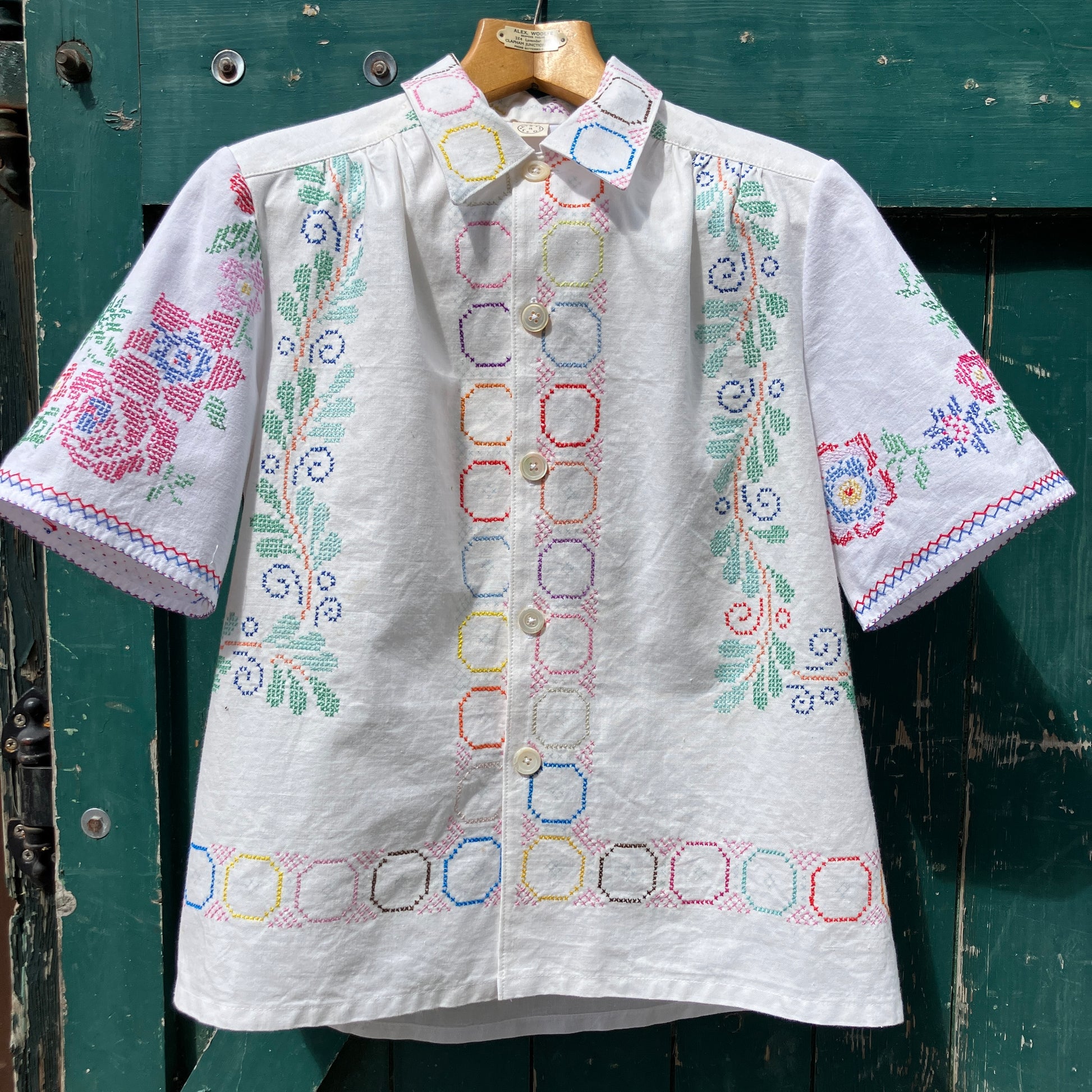Shirt made from a selection of vintage cotton tablecloths with floral and geometric cross stitch patterns