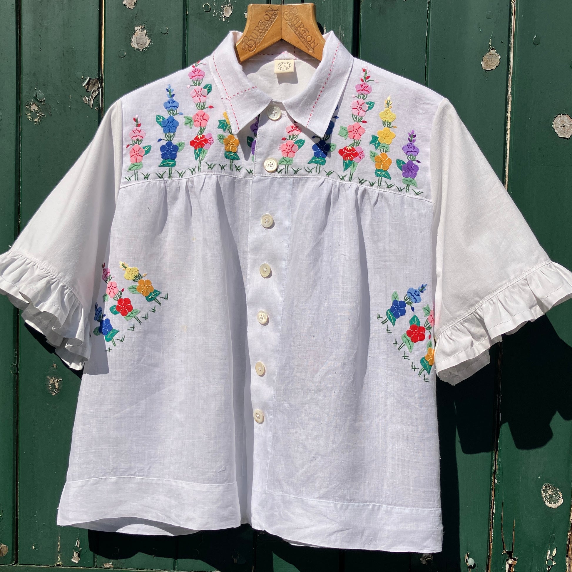 Blouse with ruffle sleeves made from a reclaimed linen tablecloth with floral applique