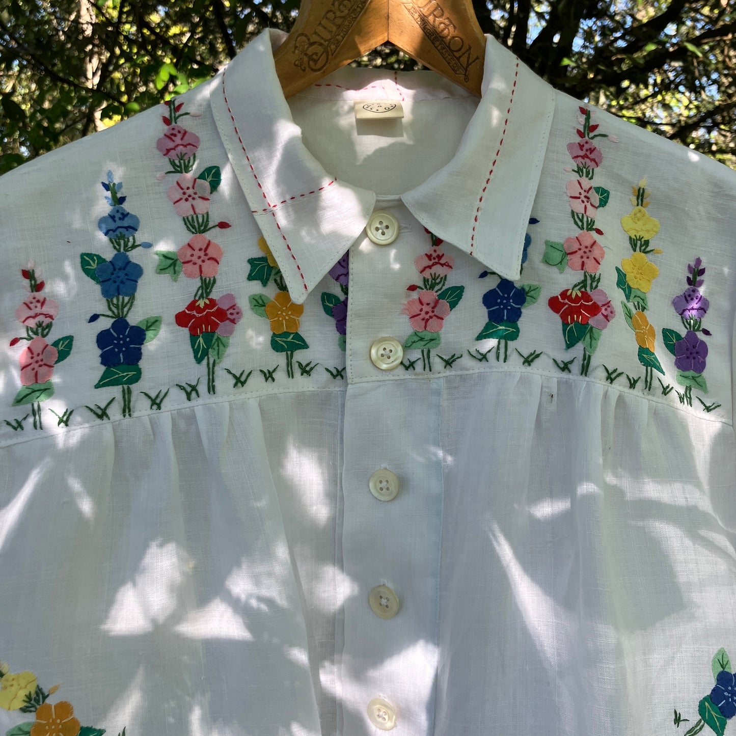 Blouse with ruffle sleeves made from a reclaimed linen tablecloth with floral applique