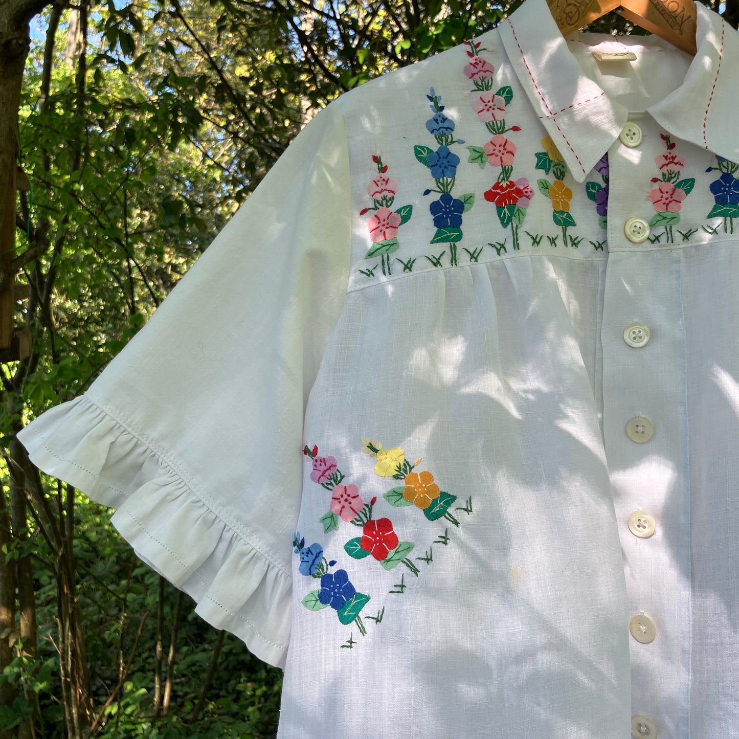 Blouse with ruffle sleeves made from a reclaimed linen tablecloth with floral applique