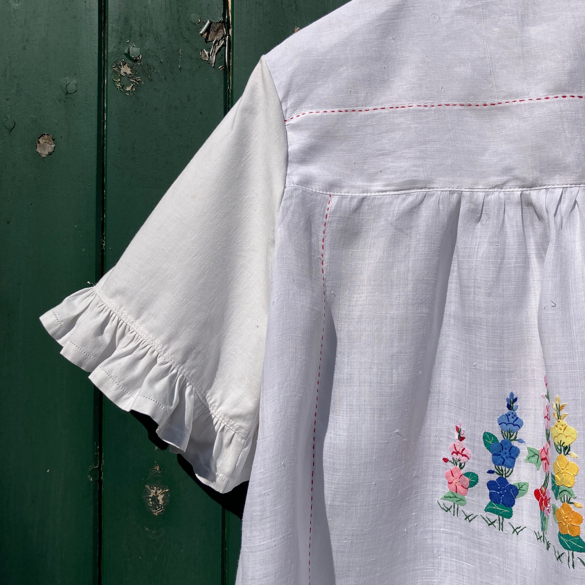 Blouse with ruffle sleeves made from a reclaimed linen tablecloth with floral applique