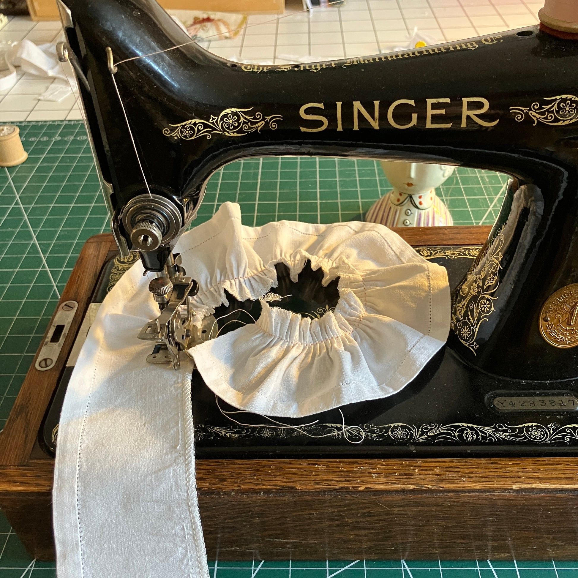 Vintage Singer sewing machine used to make sleeve ruffles on blouse with ruffle sleeves made from a reclaimed linen tablecloth with floral applique