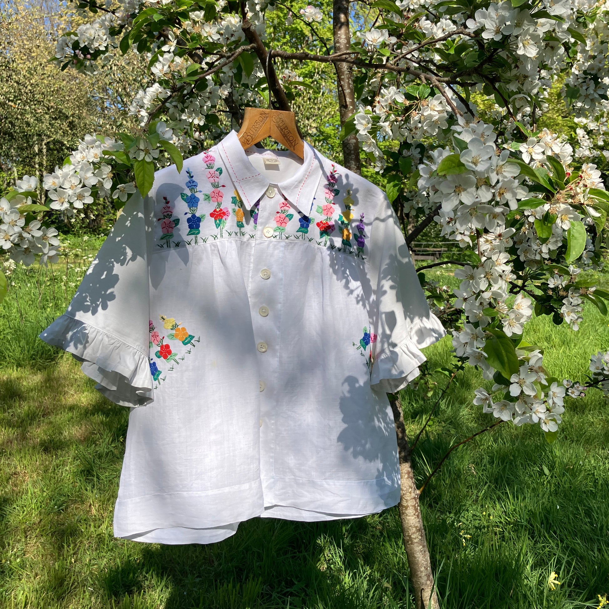 Blouse with ruffle sleeves made from a reclaimed linen tablecloth with floral applique