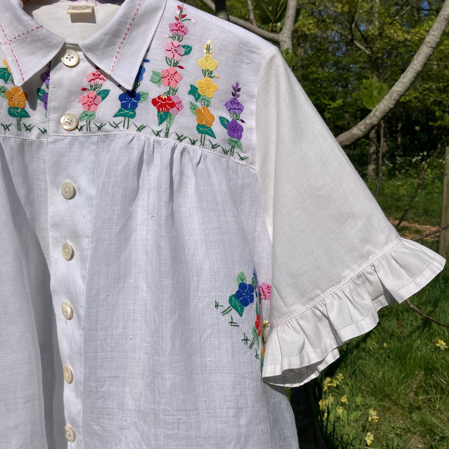 Blouse with ruffle sleeves made from a reclaimed linen tablecloth with floral applique