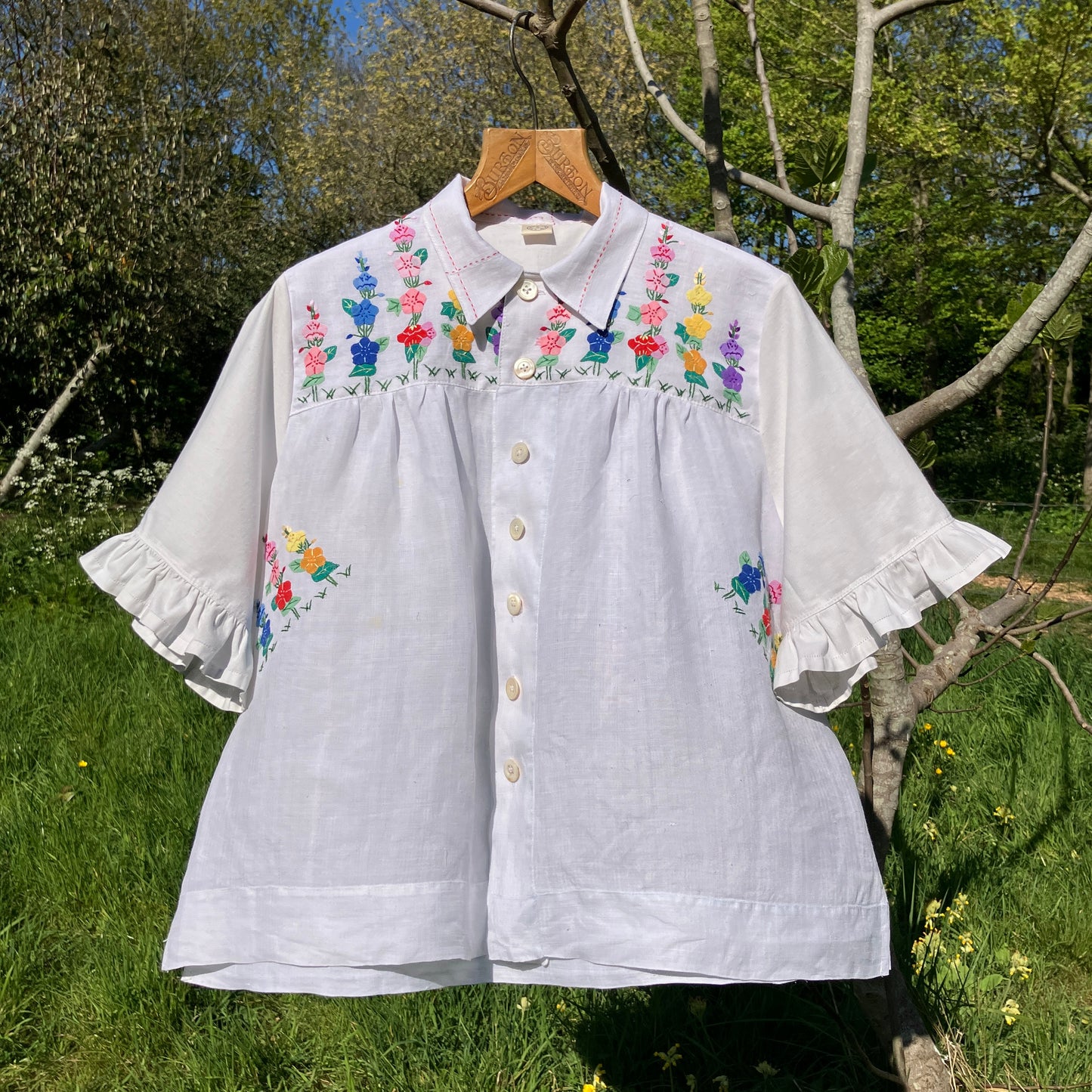 Blouse with ruffle sleeves made from a reclaimed linen tablecloth with floral applique