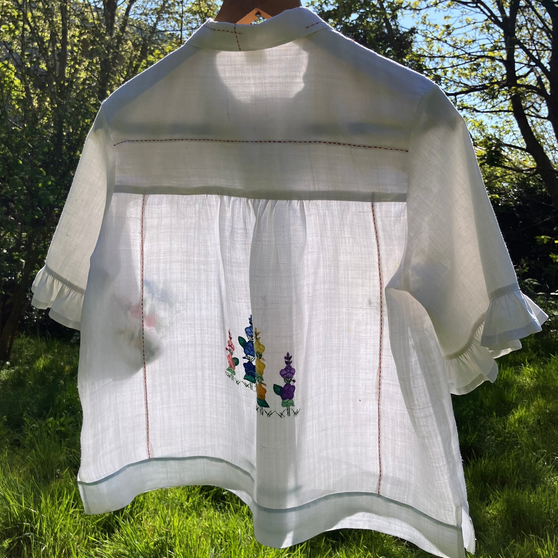 Blouse with ruffle sleeves made from a reclaimed linen tablecloth with floral applique