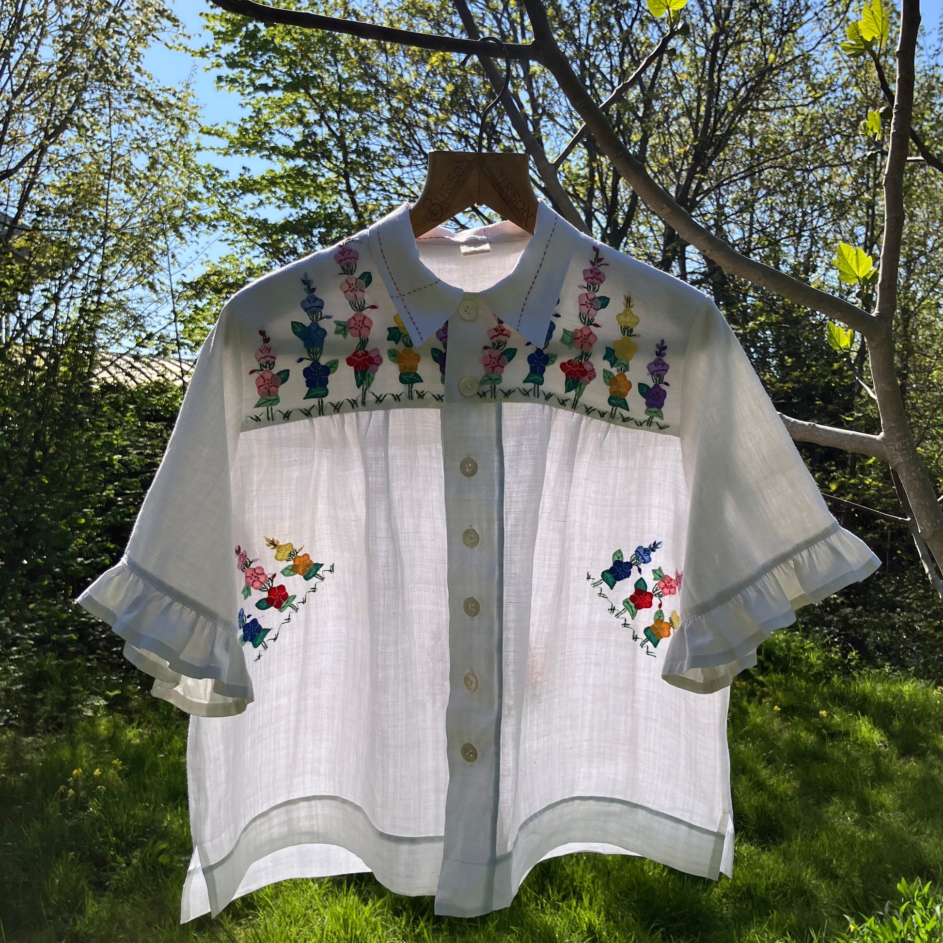 Blouse with ruffle sleeves made from a reclaimed linen tablecloth with floral applique