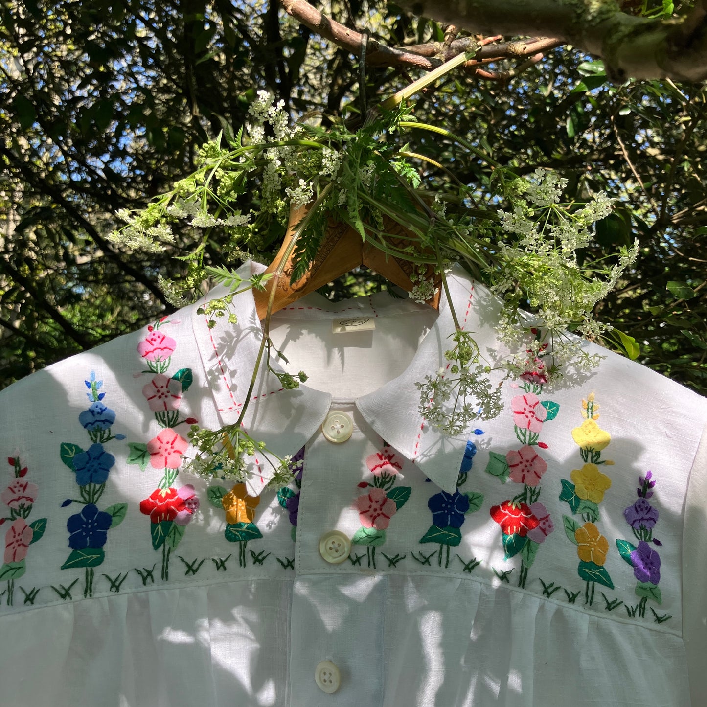 Blouse with ruffle sleeves made from a reclaimed linen tablecloth with floral applique