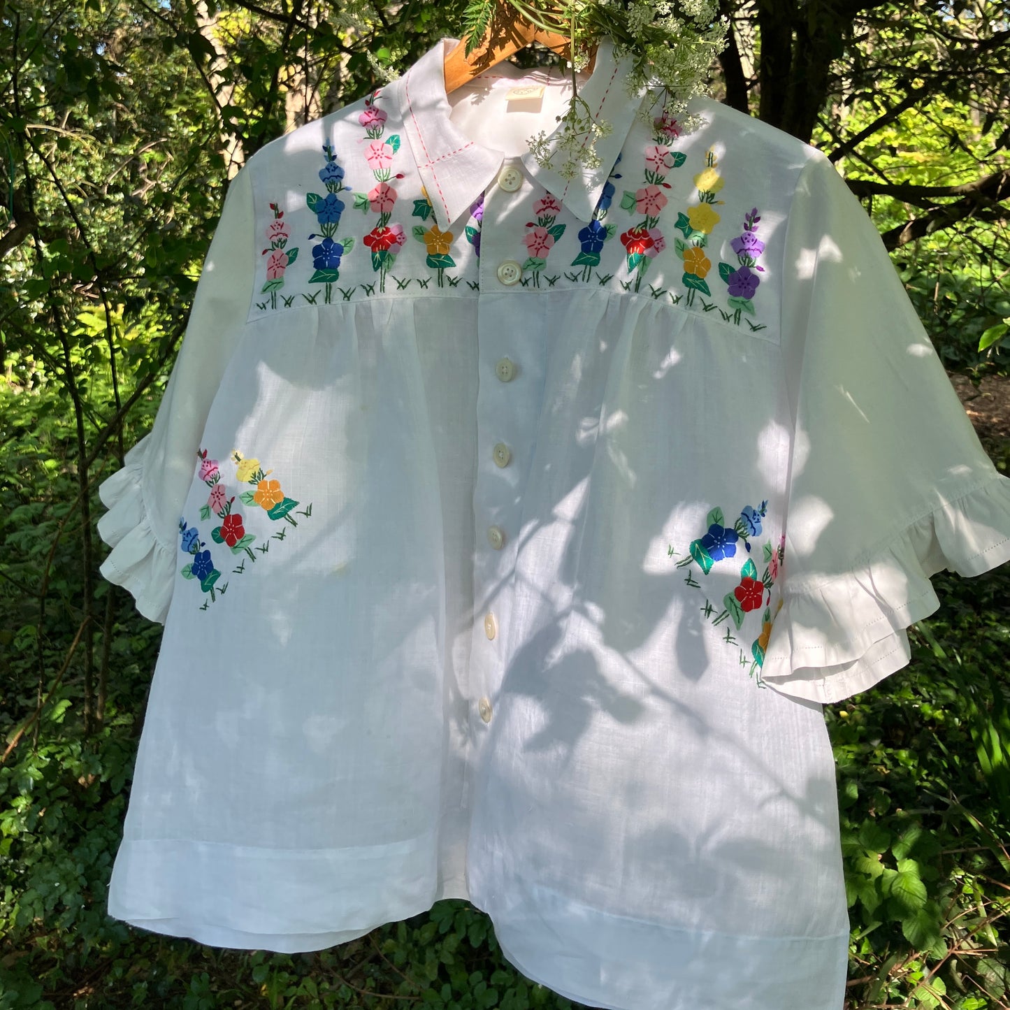 Blouse with ruffle sleeves made from a reclaimed linen tablecloth with floral applique